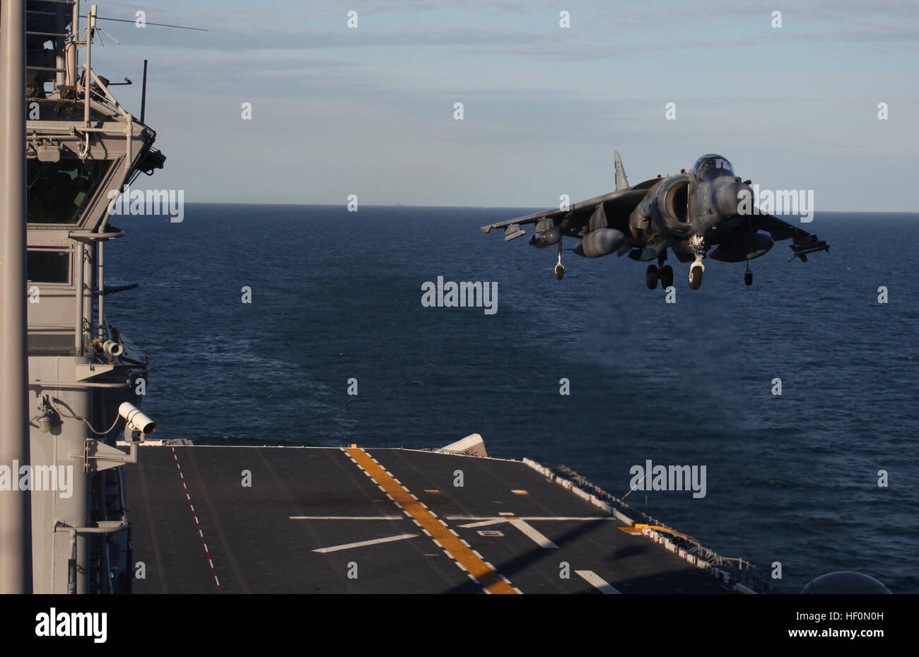An AV-8B Harrier from Marine Attack Squadron 231 uses its vertical landing capability to land aboard the USS Kearsarge for Exercise Bold Alligator 2012. The purpose of the exercise was to revitalize Navy and Marine Corps amphibious expeditionary tactics, techniques and procedures and reinvigorate its culture of conducting combined Navy and Marine Corps operations from the sea using the Navy's Expeditionary Strike Group 2 and the Marine Corps' 2nd Marine Expeditionary Brigade. Marine Corps Air Station Cherry Point Year In Review 120201-M-AF823-001 Stock Photo