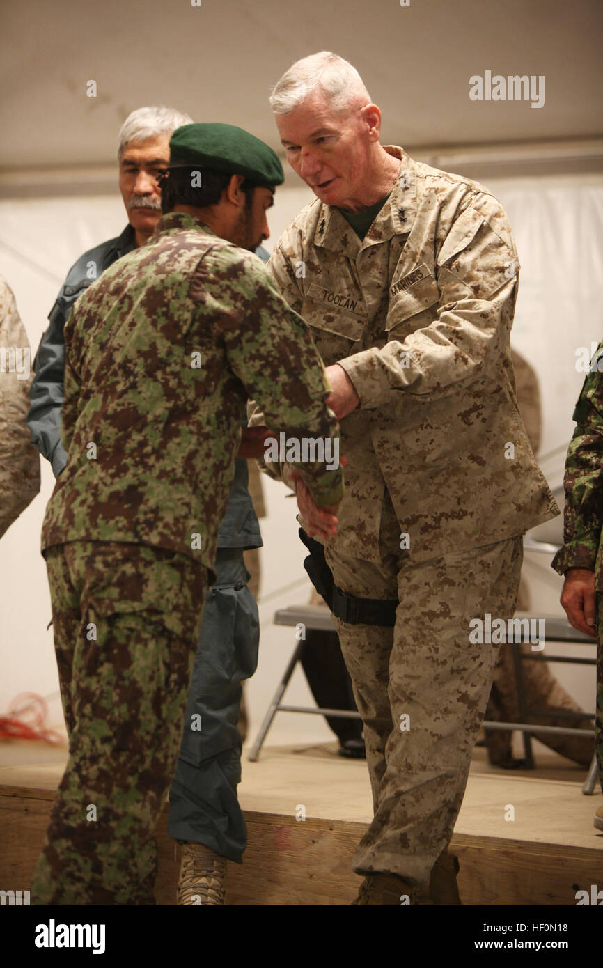 Maj. Gen. John A. Toolan, commanding general Regional Command Southwest and II Marine Expeditionary Force (Forward), presents a certificate of completion to an Afghan National Army graduate of the Explosive Hazard Reduction Course at the Joint Sustainment Academy Southwest, Feb. 2.  The course is one of many offered by U.S. and coalition forces at the academy, which teaches everything from literacy to tactical leadership. Explosive Hazard Reduction Course graduates at Helmand academy 120202-M-GF563-097 Stock Photo