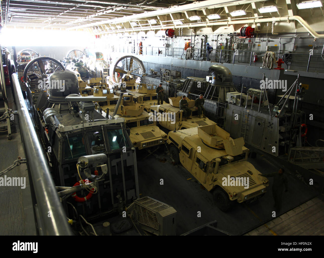 USS NEW YORK (LPD-21)- High Mobility Multi-Wheeled Vehicles, as part of Battalion Landing Team 1st Battalion, 2nd Marine Regiment, 24th Marine Expeditionary Unit, are loaded onto Landing Craft Air Cushioned (LCAC) hovercrafts Feb. 4, 2012. Prior to executing a rehearsal beach landing for a simulated raid, the LCACs debarked from here as the 24th MEU conducts their final at-sea training exercise.  The 24th MEU is conducting their Certification Exercise (CERTEX) with the Iwo Jima Amphibious Ready Group scheduled Jan. 27 to Feb. 17, which includes a series of missions intended to evaluate and cer Stock Photo