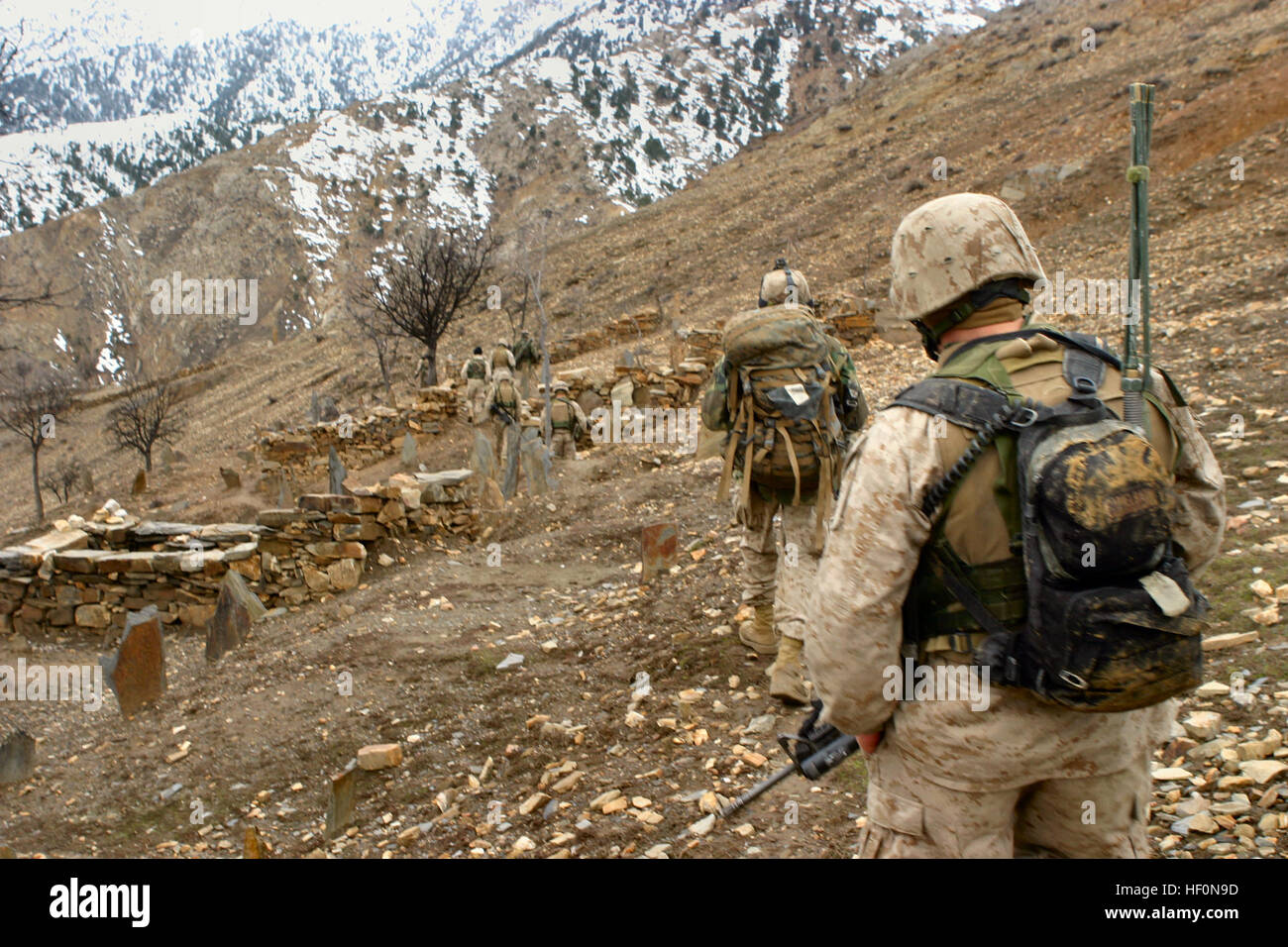 Marines of Kilo Company, 3rd Battalion, 3rd Marine Regiment, patrol on the outskrits of a village during Operation Mavericks, an operation that Marines conducted to capture suspected Anti Coaltion Forces in the vicinity of Methar Lam, Afghanistan on March 20, 2005. 3rd Battalion, 3rd Marines is conducting security and stabilization operations in support of Operation Enduring Freedom. (U.S. Marine Corps photo by Corporal James L. Yarboro) Released 3rd Battalion 3rd Marines - Methar Lam Stock Photo