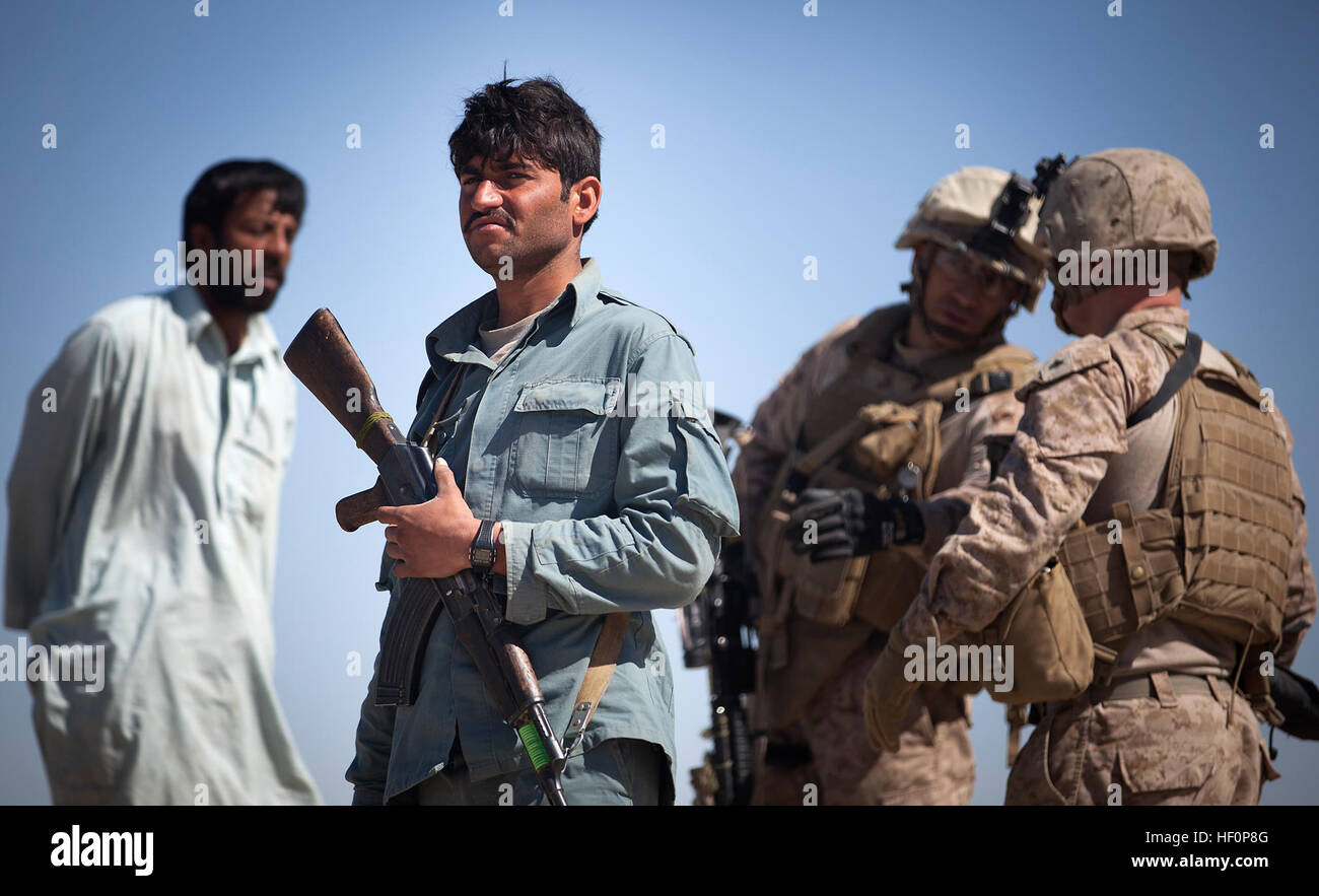Afghan National Police patrolman Dost Mohammad (second from left) waits ...