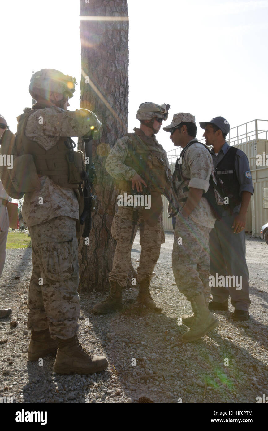 U.S. Marine Corps Cpl. Sean Gallagher with Lima Company, 3rd Battalion, 9th Marines, speaks with an Afghan interpreter and Afghan police role players during a counter insurgency field exercise aboard Camp Lejeune, N.C., April 15, 2012. The Marines conducted the training to prepare for an upcoming deployment. (U.S. Marine Corps photo by Lance Cpl. Robert Walters) 3-9 Counter insurgency training 120415-M-DK975-043 Stock Photo