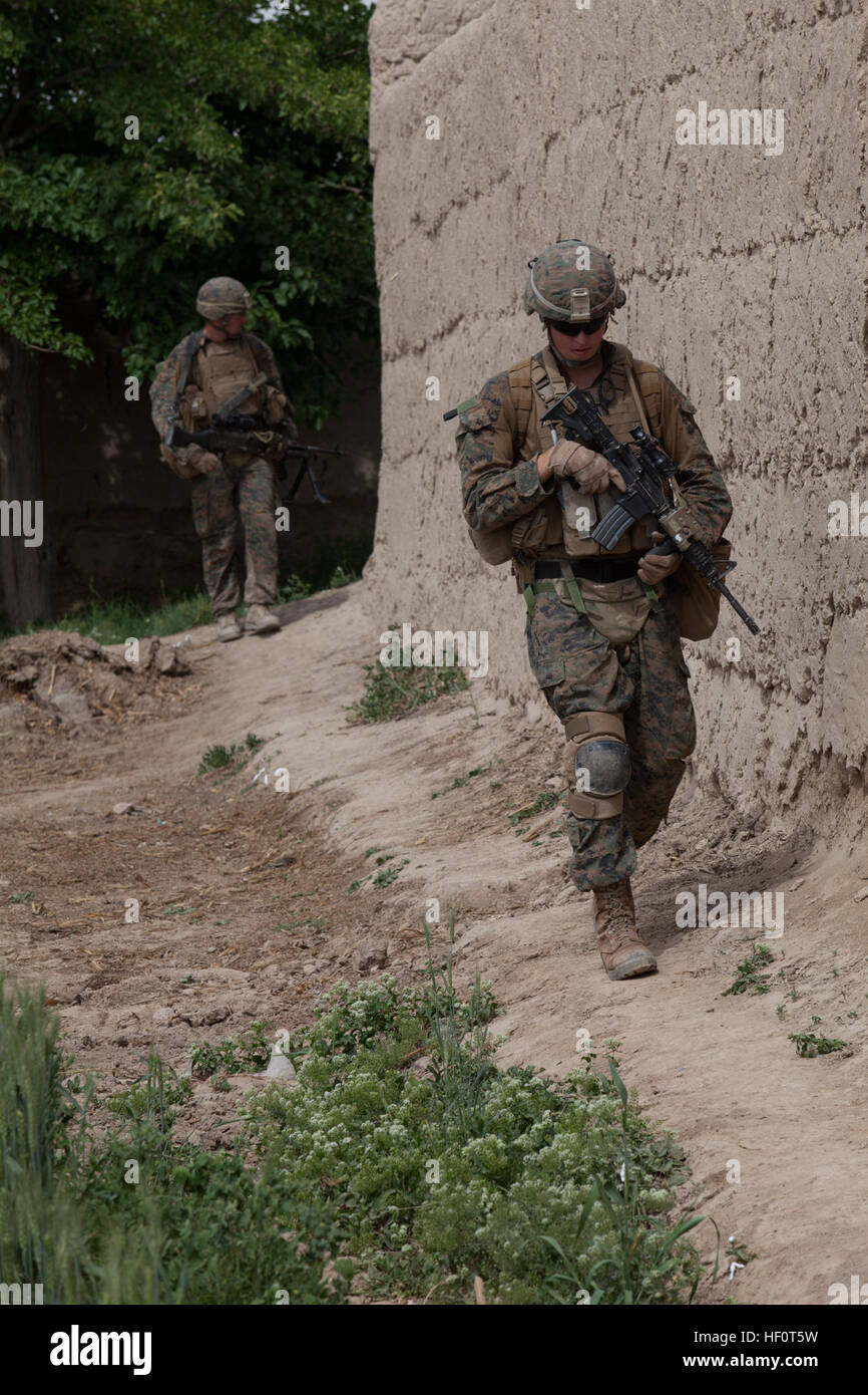 U.S. Navy Hospital Corpsman Third Class Shawn Borg, front, with Police Advisor Team 3, Alpha Company, 1st Battalion, 7th Marine Regiment, Regimental Combat Team 6, takes part in a patrol in Sangin, Helmand province, Afghanistan May 8, 2012. Marines and Sailors conducted the patrol to provide security in the area. 1-7 Patrols Sangin 120508-M-VH365-016 Stock Photo