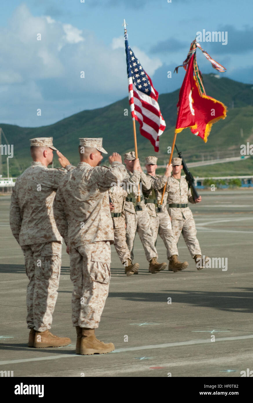 The Color Guard passes as Lt. Col. Timothy Miller, incoming commanding officer, Marine Medium Tiltrotor Squadron 363, and Lt. Col. Mark Revor, outgoing commanding officer, Marine Heavy Helicopter Squadron 363, render salutes during the Pass in Review portion of the redesignation and change of command ceremony between Hangars 101 and 102, May 10. The Lucky Red Lions were redesignated from HMH-363 to Marine Medium Tiltrotor Squadron 363, and moved to Marine Corps Air Station Miramar, in California. Lt. Col. Mark Revor, outgoing commanding officer, HMH-363, turned command over to Lt. Col. Timothy Stock Photo