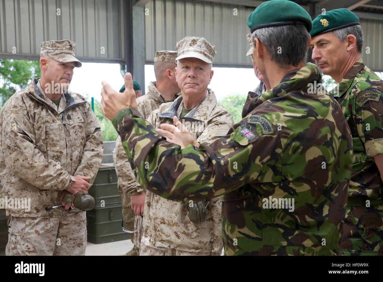 U.S. Marine Corps Gen. James F. Amos, center, the commandant of the Marine Corps, and Sgt. Maj. Micheal P. Barrett, left, the sergeant major of the Marine Corps, speak with British Royal Marines at the Commando Training Center Royal Marines in Lympstone, Devon, England, June 6, 2012. Amos visited the facility to observe training practices. (U.S. Marine Corps photo by Sgt. Mallory S. VanderSchans/Released) United Kingdom tour 120606-M-LU710-175 Stock Photo