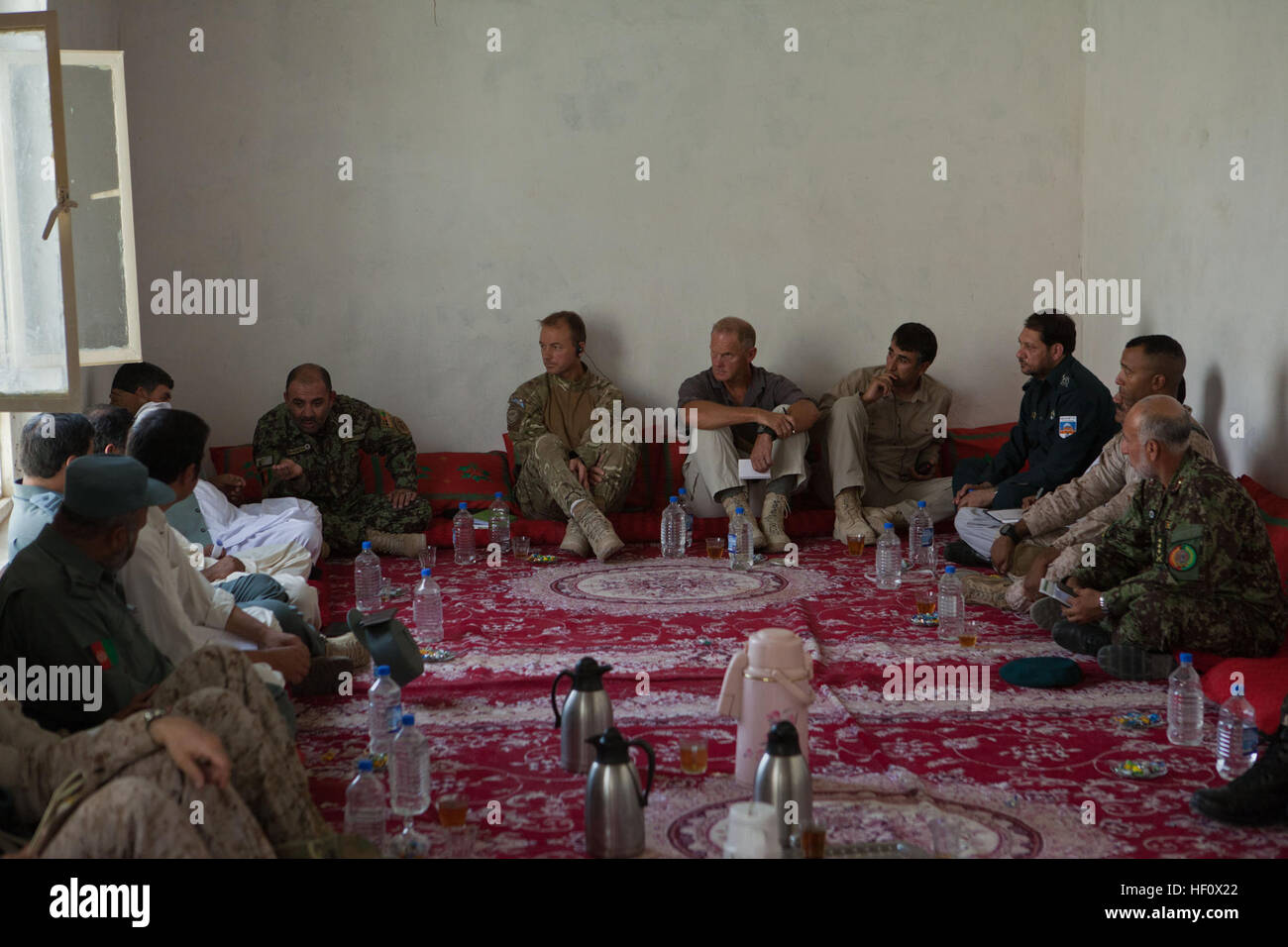 British Army Brigadier Stuart Skeates, deputy commander of Regional Command (Southwest), listens to Afghan National Army Brig. Gen. Abdul Wasea talk during a security meeting at Delaram district center June 27, 2012. Wasea is the commanding general of 2nd Brigade, 215th Corps. Senior Afghan National Security Force and district- and provincial-level leaders met with Brig. Skeates and Marines from Regimental Combat Team 6 to discuss the impending security transition in Delaram from coalition forces to ANSF. Afghans ready for security responsibility in Delaram 120627-M-DM345-027 Stock Photo