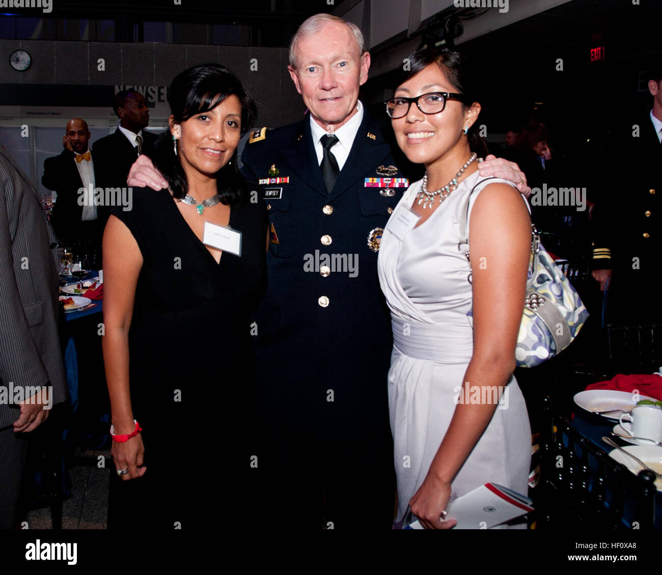 Chairman of the Joint Chiefs of Staff Army Gen. Martin E. Dempsey, center, poses for a photo with Shandiin Sam, right, a ThanksUSA scholarship recipient, and her mother during the 2012 ThanksUSA Treasure Our Troops Gala July 11, 2012, in Washington, D.C. ThanksUSA is a nonpartisan organization that encourages Americans to thank the men and women of the U.S. military by helping provide need-based college, technical and vocational school scholarships for service members' children and spouses. (Photo by Staff Sgt. Sun L. Vega) 2012 ThanksUSA Treasure Our Troops Gala 120711-D-TT930-005 Stock Photo