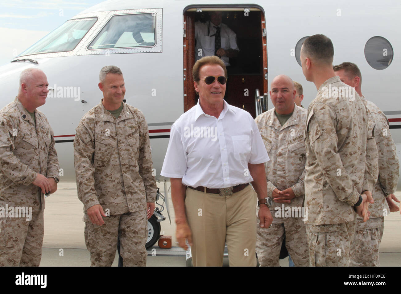 Arnold Schwarzenegger arrives on the flight line aboard Marine Corps Air Station Camp Pendleton, Calif., to greet Marines before heading to the Camp Pendleton Bull Dog Theatre to sign autographs for Marines and families, July 13. Terry Crews, Randy Couture and Dolph Lundgren also made an appearance to sign autographs for fans. Marines and families were given a wristband to get into the theatre to see the sneak peek of Expendables 2. Expendables 2 stars sign autographs for true action heroes 120713-M-XW271-028 Stock Photo