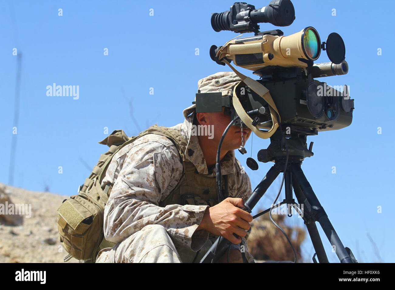 Sgt. Shaye Carter, platoon sergeant, Personal Security Detail, Regimental Combat Team-7, looks through the Portable Lightweight Designator/Rangefinder during a Fire Support Coordination Exercise as part of Enhanced Mojave Viper 7-12, July 24. Carter, the joint fires observer for PSD, coordinated with close air support to ensure simulated targets were properly destroyed. 'Raining Steel,' Marines practice close air support tactics 120724-M-IV927-010 Stock Photo