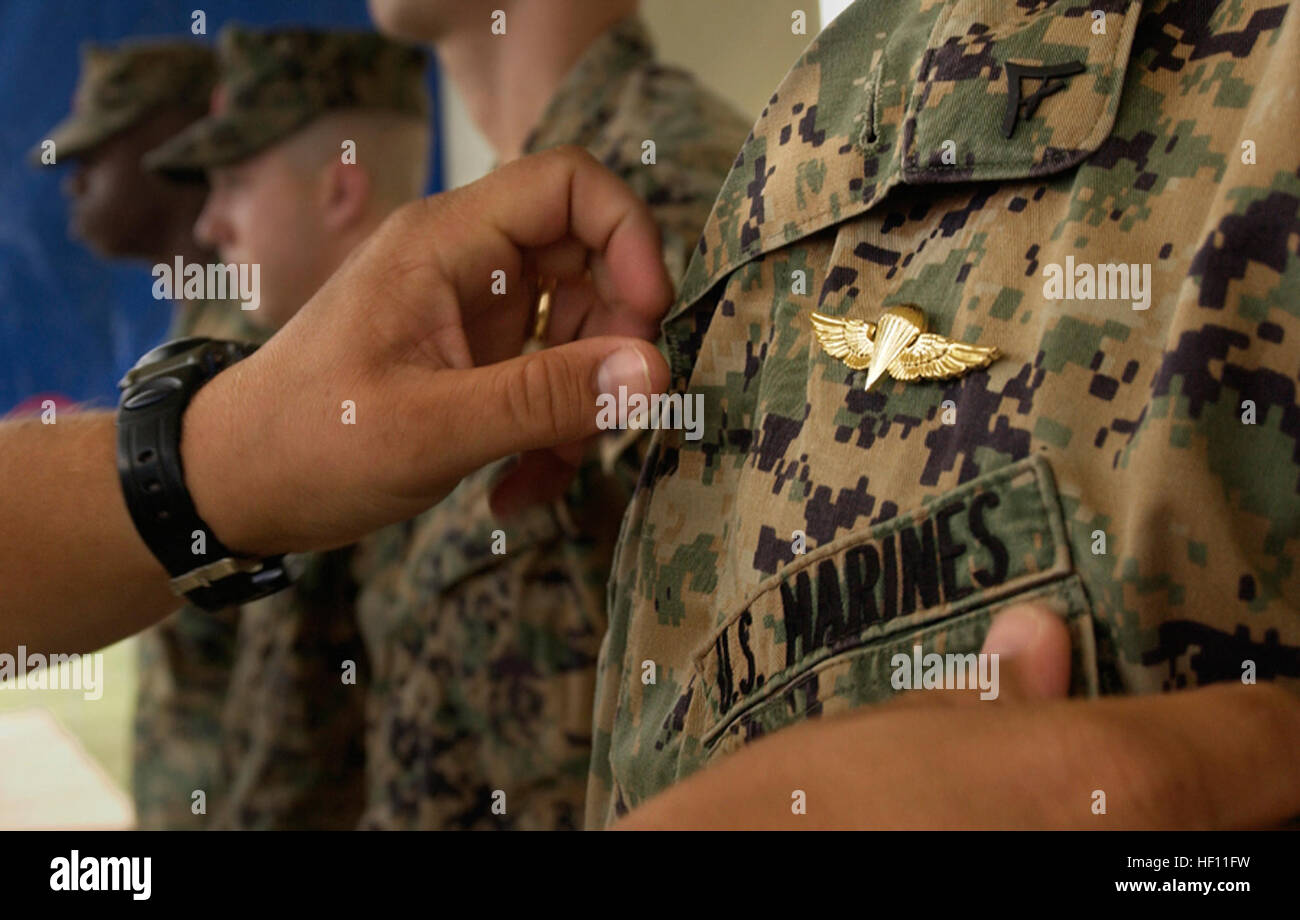 051108-M-3819R-002 CAMP FOSTER, OKINAWA, Japan ・Staff Sgt. Steven Parker  pins Navy and Marine Corps Parachutist Insignia on Lance Cpl. Brandon  Gipson痴 uniform. Gipson and 10 other Marines with Air Delivery Platoon,  Landing