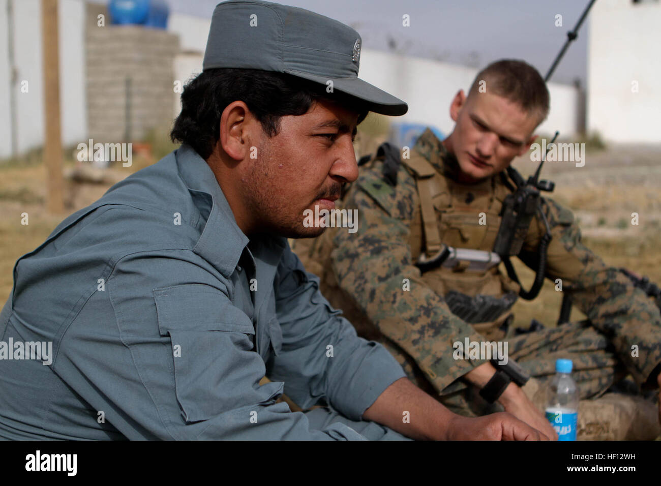 Afghan Local Police 3rd Lt. Shah Mohammad meets with Sgt. Ben Edwards, squad leader, Lima Company, 3rd Battalion, 9th Marine Regiment, Regimental Combat Team 7, Nov. 27, 2012. The two enjoyed chai tea and talked about a local school that recently opened. Return to Marjah, Marines work with much improved ANSF 121127-M-PC317-007 Stock Photo