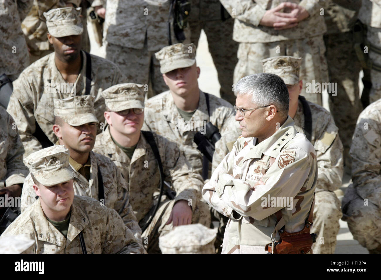 060211-M-7772K-004 AL Asad, Iraq (Feb. 11, 2006) - Multi-National Forces Commander, U.S. Army Gen. George Casey, speaks with Marines from Regimental Combat Team 2 about their achievements made during Operation Iraqi Freedom. In support of Operation Iraqi Freedom, 2nd Marine Division is deployed to conduct counter-insurgency operations to isolate and neutralize anti-Iraqi forces; support the continued development of Iraqi Security Force; support Iraqi reconstruction and democratic elections and facilitate the creation of a secure environment that enables Iraqi self-reliance and self-governance. Stock Photo
