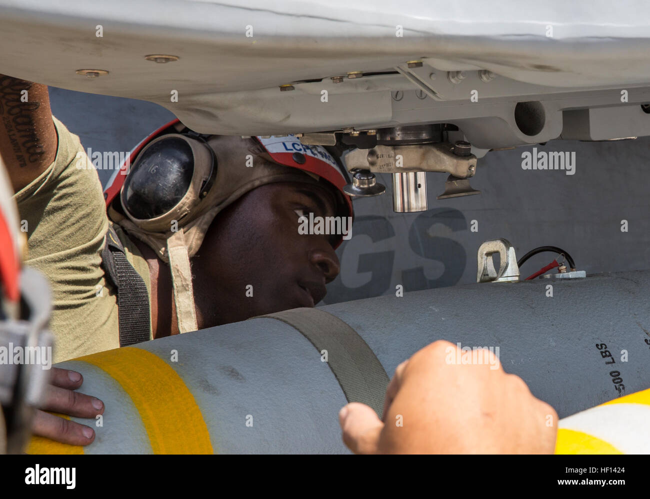 Marine ordnance personnel from VMFA(AW)-225 load MK-82 low-drag bombs ...