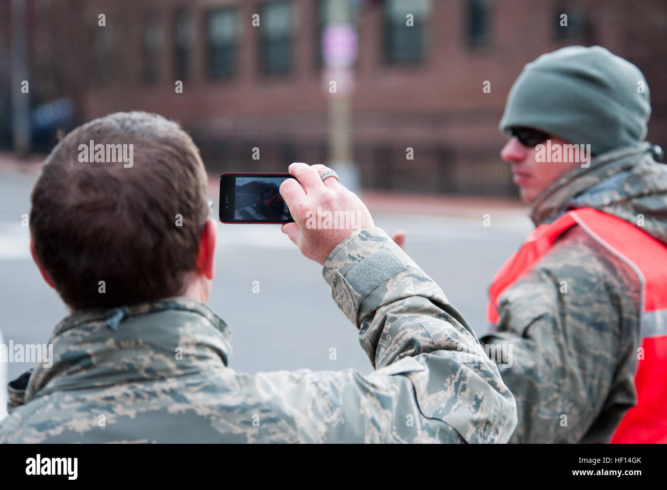 Air Force Master Sgt. Dennis Young, public affairs with the 113th Fighter Wing District of Columbia National Guard, takes a photo of Army soldiers providing crowd and traffic support for the Presidential Inauguration. The 57th Presidential Inauguration was held in Washington Monday, Jan. 21, 2013. (Official U.S. Air Force photo by Tech. Sgt. Eric Miller/ New York Air National Guard) National Guardsmen support 57th Presidential Inauguration 130121-Z-QU230-128 Stock Photo