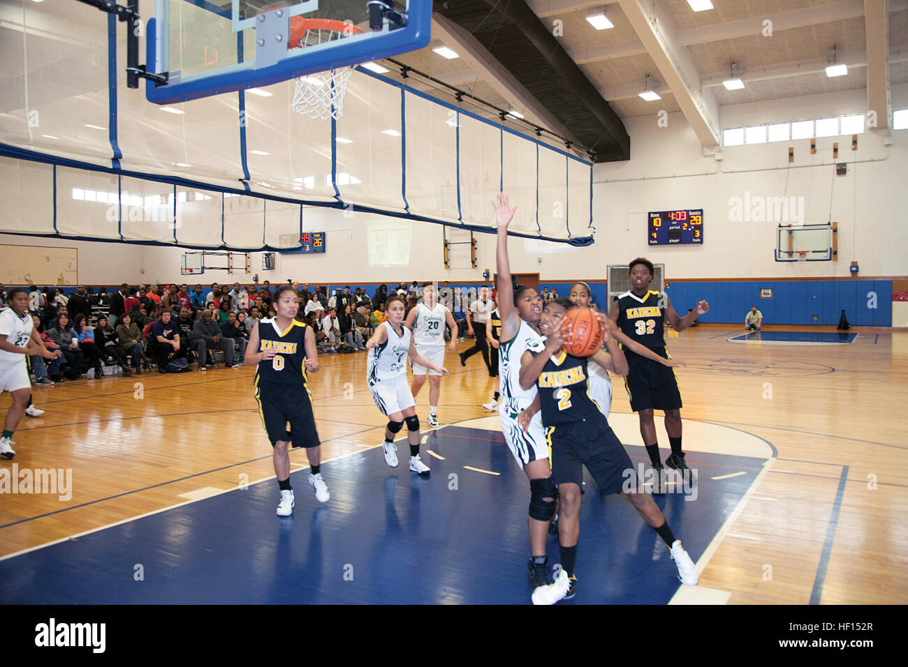 Jasmine Rhodes, No. 2 of the Kadena Panthers, aggressively fends off a defender Jan. 27 during the championship game against the Kubasaki Dragons in the Okinawan-American Friendship Basketball Tournament 2013 at Risner Gym on Kadena Air Base. The Kadena High School girls and boys teams both won first place in the tournament. Photo by Lance Cpl. Adam B. Miller Tournament builds friendships 130127-M-OY715-063 Stock Photo