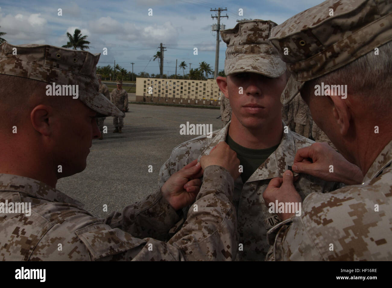 Gen. John M. Paxton Jr., Assistant commandant of the Marine Corps, promotes Lance Cpl. Jonathan T. Kobarg to Cpl. after being selected during the 1st quarter meritorious corporal board, during Exercise Guahan Shield. Guahan Shield is an exercise designed to facilitate multiservice engagements, set conditions for bilateral and multilateral training opportunities, and support rapid response to potential theater crises and contingency operations in the Asia-Pacific region. Paxton is visiting several sites, bases and stations as he travels throughout the region. Paxton took over as the Assistant C Stock Photo