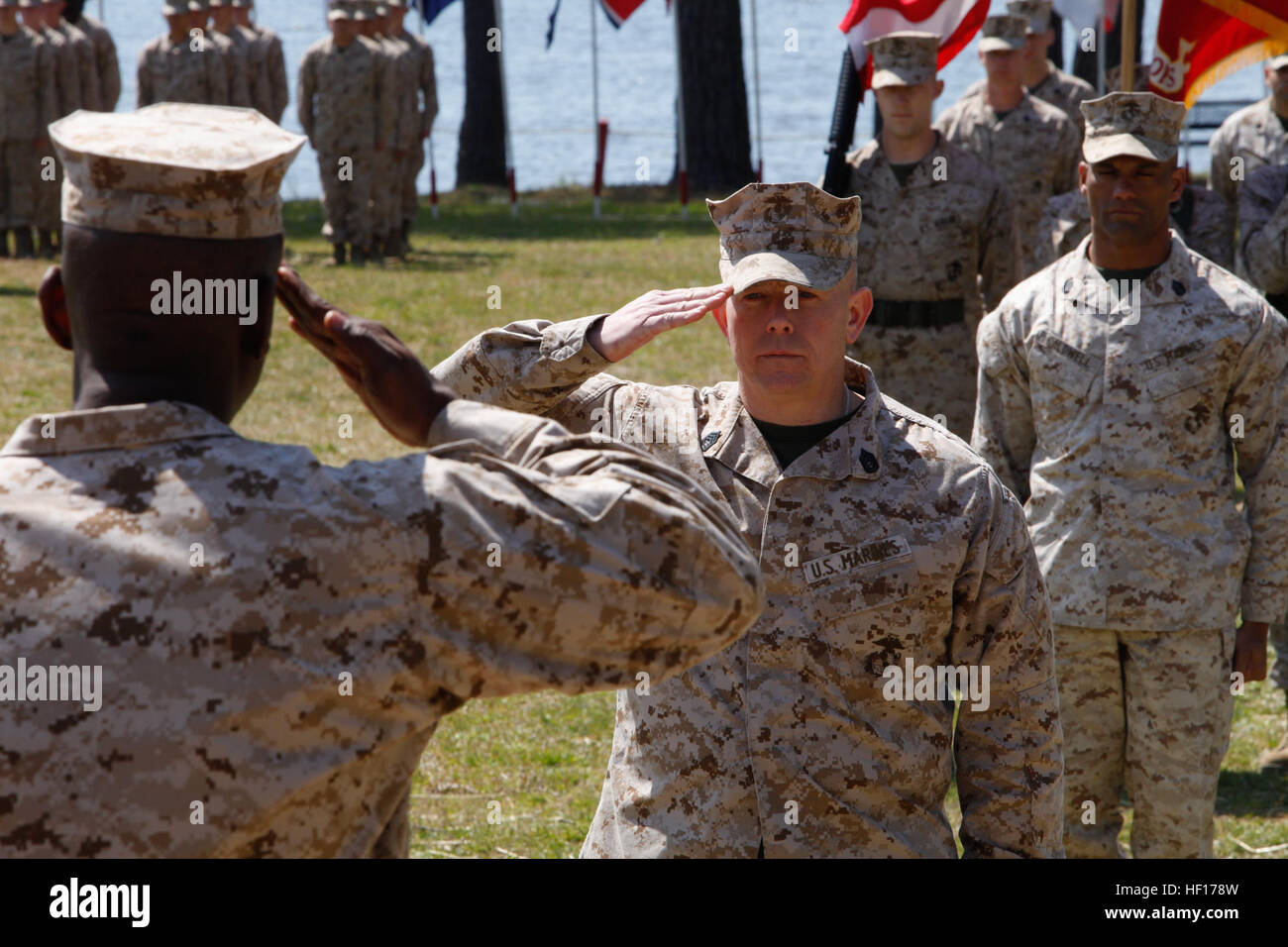 U. S. Marine Gunnery Sergeant Peter Gosnell (right), Instructor, Motor Transportation Maintenance Instructional Company(MTMIC), Logistics Operations School (LOS), Marine Corps Combat Service Support Schools (MCCSSS), renders a hand salute as the Commander of Troops to Major Jerry Godfrey (Left), Commanding Officer, MTMIC, LOS, MCCSSS, during Gunnery Sergeant Markus Caldwells' retirement ceremony on Camp Johnson N.C., March 28, 2013. Friends, family, and service members gathered to celebrate Gunnery Sergeant Caldwell for his 22 years of faithful service to the United States Marine Corps. (U.S.  Stock Photo