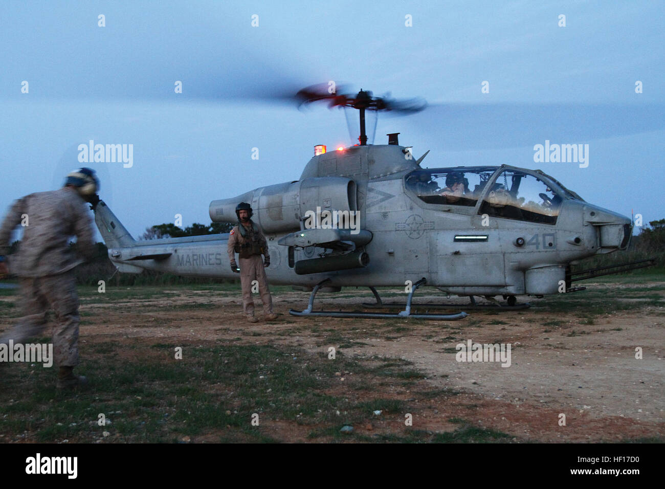 Marines prepare to refuel an AH-1W Super Cobra helicopter during a forward-arming and refueling point training exercise April 3 at the Central Training Area. Upon landing, the Cobra was refueled as part of an exercise to familiarize Marines with the procedures for refueling a helicopter while the engine is still running in order to expedite the aircraft's return to the air. The helicopter is a part of HMM-262. (Photo by Lance Cpl. Nicholas S. Ranum) Marines forward-arm, refuel helicopters during FARP exercise 130403-M-DU087-742 Stock Photo