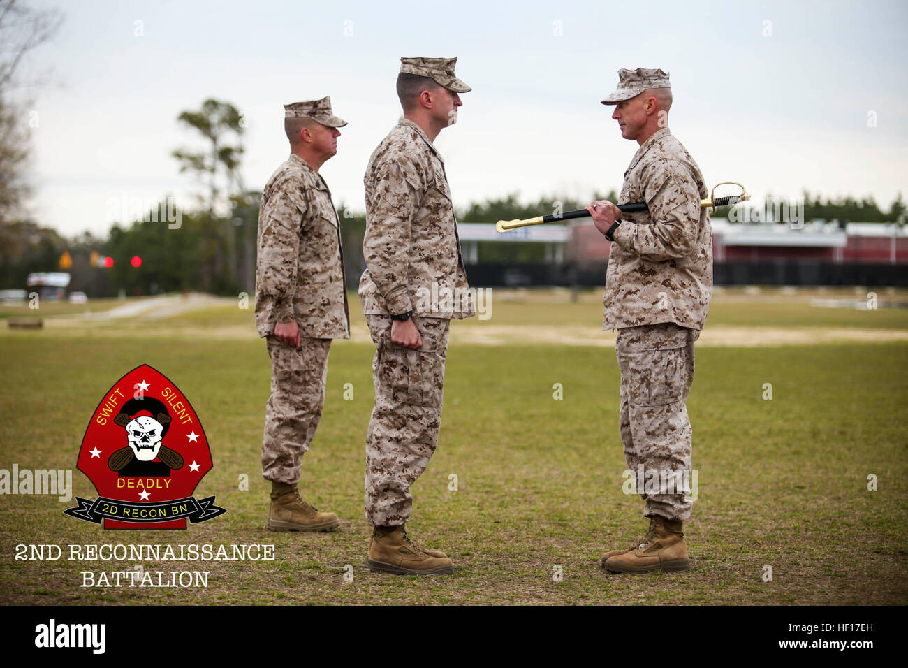 Sergeant Maj. George Rabidou III (left), the former sergeant major for 2nd Reconnaissance Battalion and Sgt. Maj. Garritt Duncan (right), the new sergeant major for 2nd Recon Bn., stand with Lt. Col. Robert Revoir, commanding officer, 2nd Recon Bn., during the relief and appointment ceremony, April 4, 2013. Duncan was previously the sergeant major for 1st Marine Special Operations Battalion, and Rabidou will now be the sergeant major for 8th Marine regiment, 2nd Marine Division. 2nd Recon Battalion relief and appointment ceremony 130404-M-PE262-001 Stock Photo