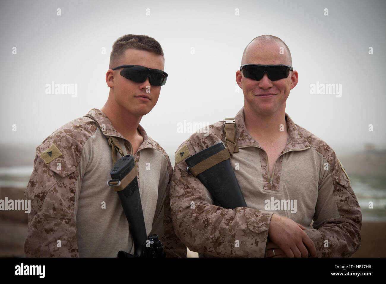 U.S. Marine Corps Lance Cpls. Mark Pittman, left, and Mark Howell, both with 3rd Battalion, 4th Marine Regiment, Regimental Combat Team 7, pose for a photo at the Afghan Uniformed Police station during Operation Eagle in Delaram city, Helmand province, Afghanistan, April 8, 2013. Pittman and Howell were part of the security force detail for the 4th Brigade, 215th Corps Brigade Advisor Team that was conducting Operation Eagle, an Afghan-led clearing operation. (U.S. Marine Corps photo by Staff Sgt. Ezekiel R. Kitandwe/Released) Brotherhood 130408-M-RO295-170 Stock Photo