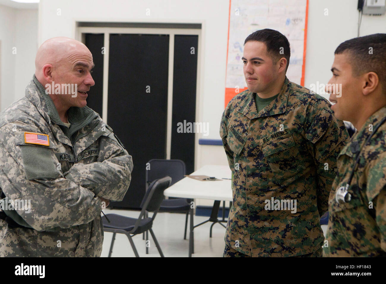 Maj. Gen. Thomas Katkus, adjutant general for the Alaska Department of Military and Veterans Affairs, talks with Lance Cpl. Moises Zepedaserrano of 4th Medical Battalion, 4th Marine Logistics Group, Marine Forces Reserve, and Navy Petty Officer 2nd Class David Pereira, hospital man, 4th Dental Bn., 4th MLG, MARFORRES, at the Noorvik School, April 20. Katkus was one the distinguished visitors who traveled to three of the 12 Alaskan villages taking part in Innovative Readiness Training Arctic Care 2013. The exercise is a multi-service humanitarian and training program that focuses on enhancing t Stock Photo