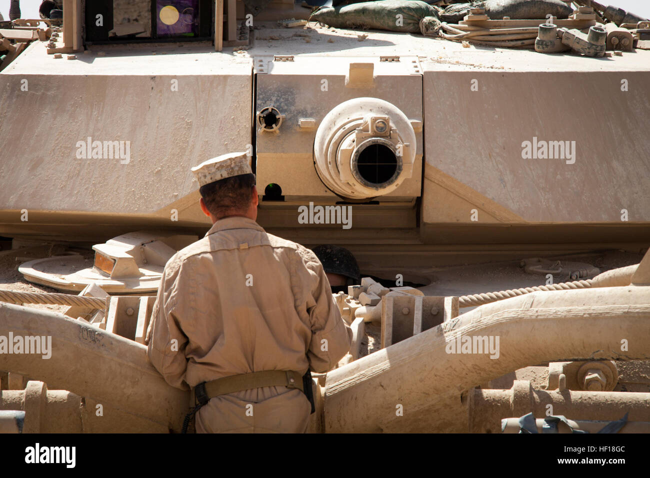 U.S. Marine Corps Staff Sgt. Paul Acevedo, a section leader from Pomona, Calif., assigned to Delta Company, 1st Tank Battalion, Regimental Combat Team 7, (RCT) 7, conducts function checks on an M1A1 Abrams tank on Camp Shir Ghazay, Helmand province, Afghanistan, April 27, 2013. Acevedo alongside the Marines and Sailors of Delta Company deployed to Afghanistan in support of Operation Enduring Freedom. (U.S. Marine Corps photo by Staff Sgt. Ezekiel R. Kitandwe/Released) Delta Company tanks roll through Shir Ghazay 130427-M-RO295-074 Stock Photo