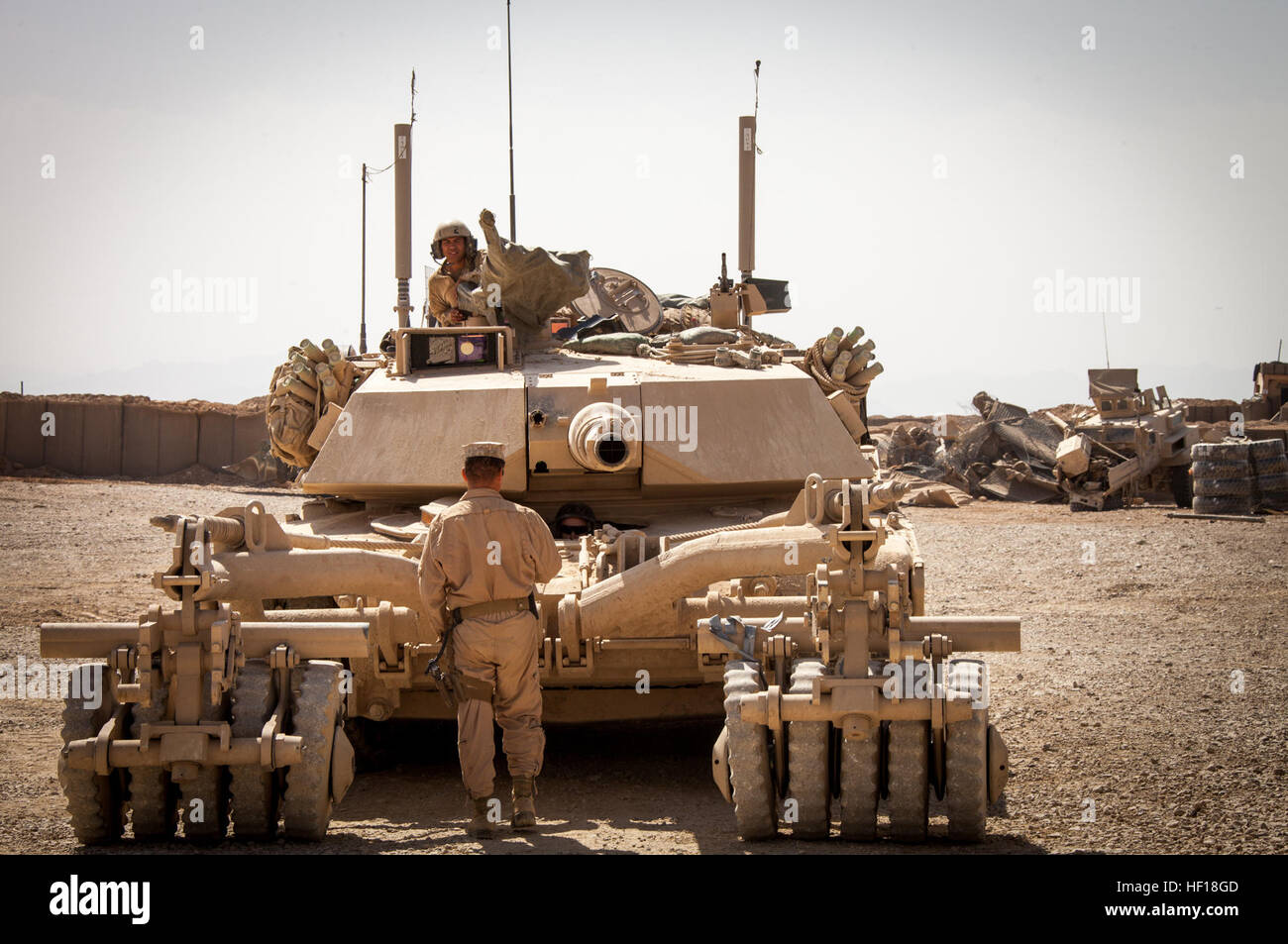 U.S. Marine Corps Staff Sgt. Paul Acevedo, a section leader from Pomona, Calif., assigned to Delta Company, 1st Tank Battalion, Regimental Combat Team 7, (RCT) 7, conducts function checks on an M1A1 Abrams tank on Camp Shir Ghazay, Helmand province, Afghanistan, April 27, 2013. Acevedo alongside the Marines and Sailors of Delta Company deployed to Afghanistan in support of Operation Enduring Freedom. (U.S. Marine Corps photo by Staff Sgt. Ezekiel R. Kitandwe/Released) Delta Company tanks roll through Shir Ghazay 130427-M-RO295-075 Stock Photo