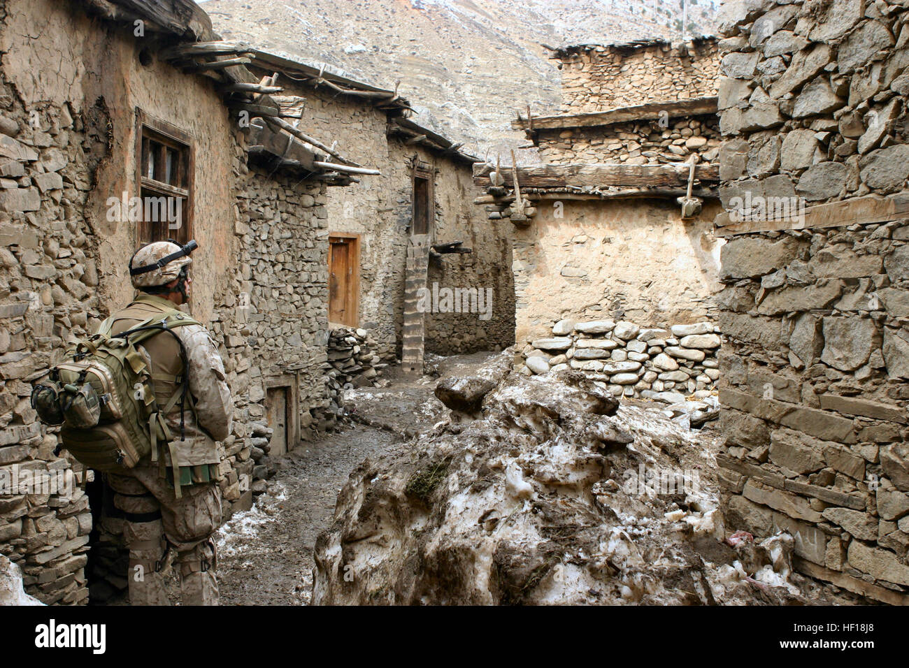 Petty Officer 2nd Class Alonzo Gonzales, a Hospital Corpman with Kilo Company, 3rd Battalion, 3rd Marine Regiment, walks through an alley looking for signs of sickness or disease during Operation Mavericks, an operation that Marines conducted to capture suspected Anti Coaltion Forces in the vicinity of Methar Lam, Afghanistan on March 19, 2005. 3rd Battalion, 3rd Marines is conducting security and stabilization operations in support of Operation Enduring Freedom. (U.S. Marine Corps photo by Corporal James L. Yarboro) Released 3rd Battalion, 3rd Marines - Afghanistan Stock Photo
