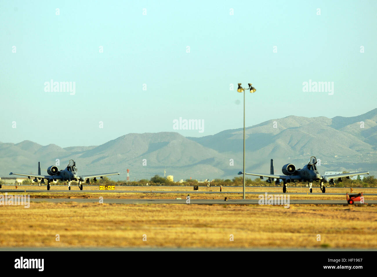 Two A-10 Thunderbolt II aircraft from Selfridge Air National Guard Base, Mich., flown by the 107th Fighter Squadron, taxi in after landing from flight operations during the Snowbird/Angel Thunder 2014 training mission at Davis-Monthan Air Force Base, Tucson, Ariz., May 12, 2014. Angel Thunder is the largest joint service, multinational, interagency combat search and rescue exercise, providing personnel recovery and combat search and rescue training for military units. (U.S. Air National Guard photo by MSgt. David Kujawa/Released) Angel Thunder 140512-Z-EZ686-067 Stock Photo