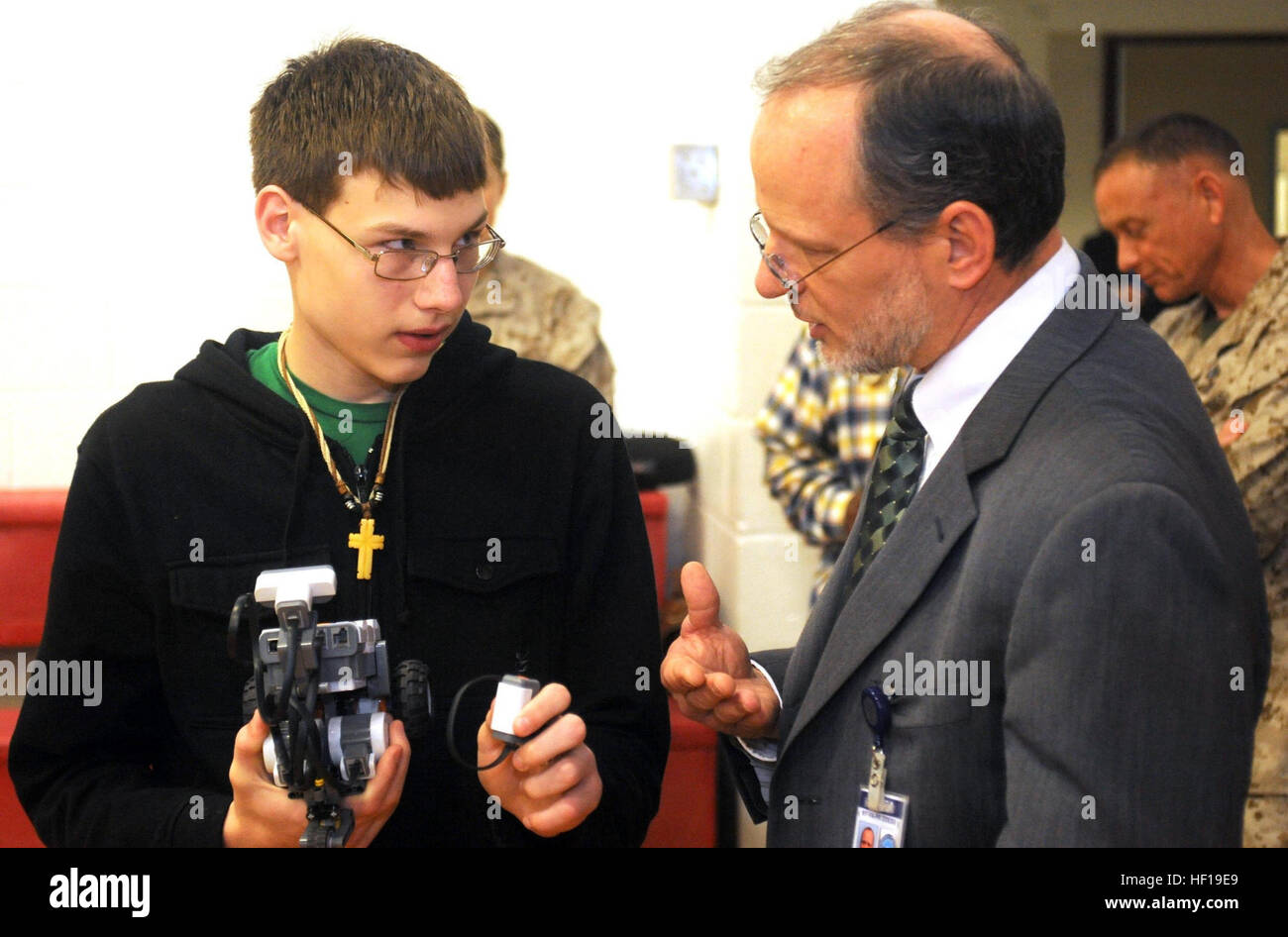 Tim, 14, explains how he programmed his robot to Mike Gould, Department of Defense Education Activity New York/Virginia/Puerto Rico District Superintendent at the Quantico Middle/High School aboard Marine Corps Base Quantico on May 9, 2013. Tim and Gould participated in the science, technology, engineering and mathematics day hosted there. (U.S. Marine Corps Photo by Pfc. Samuel Ellis/Released) STEM grows on Quantico students 130509-M-ZS544-001 Stock Photo
