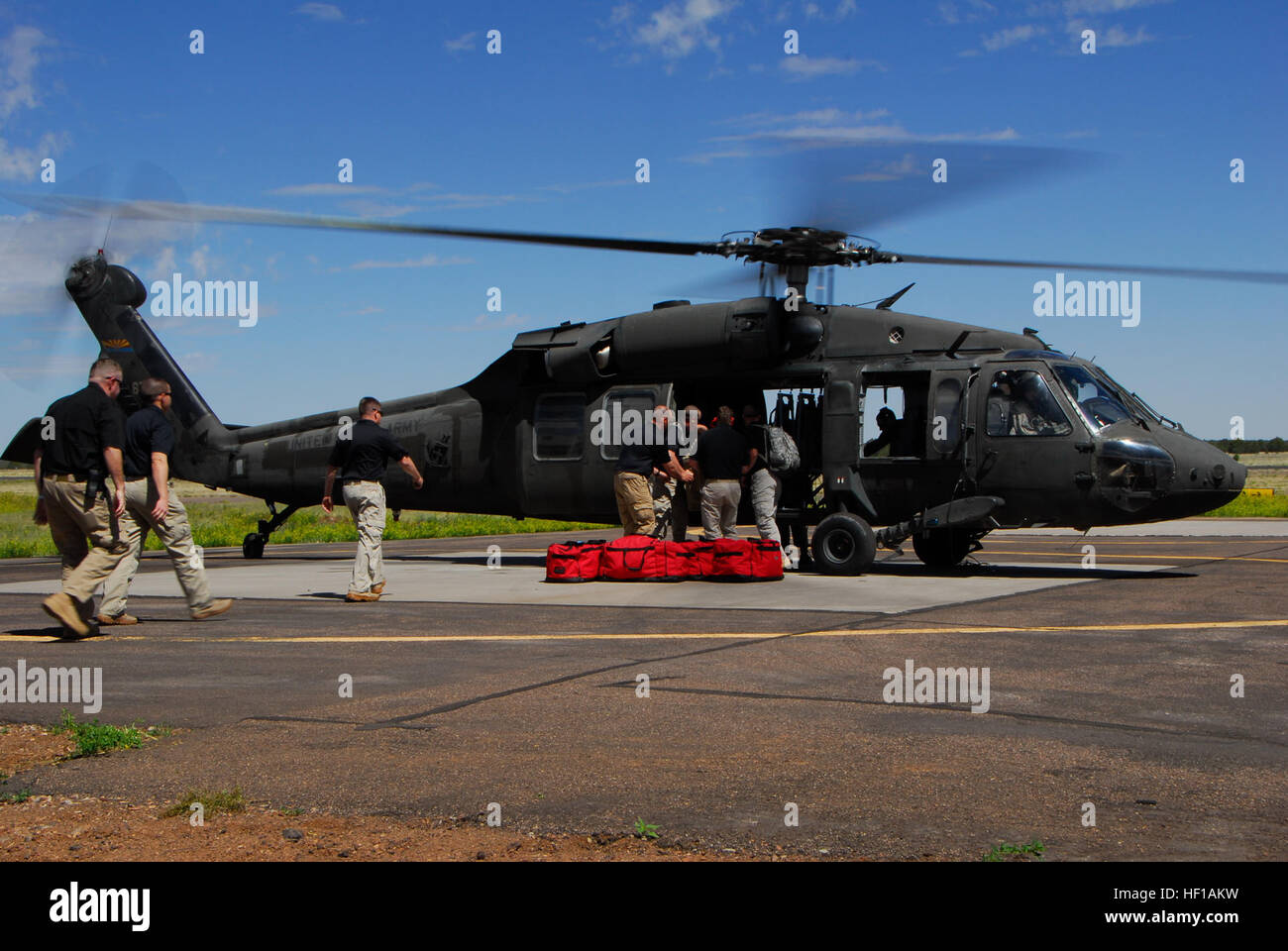 Members of the 91st Civil Support Team unload equipment from a UH-60 ...