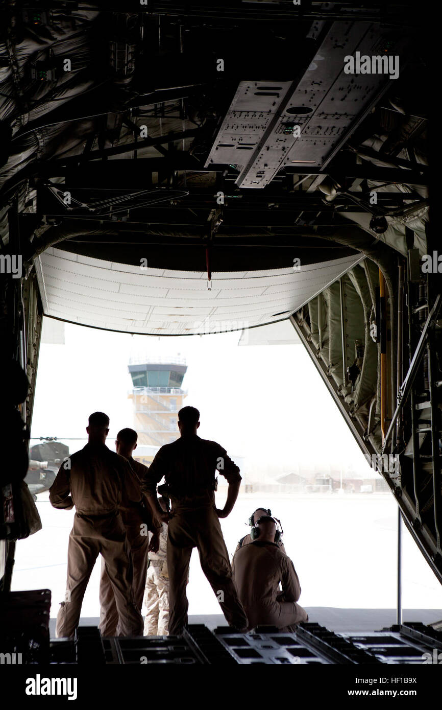 U.S. Marines with Marine Aerial Refueler Transport Squadron 252 (VMGR-252) wait on a C-130 Hercules for the arrival of the 35th commandant of the Marine Corps, General James F. Amos, at Camp Leatherneck, Helmand province, Afghanistan, June 19, 2013. Amos, the 17th sergeant major of the Marine Corps, Sgt. Maj. Micheal P. Barrett, and other staff visited Camp Leatherneck and surrounding forward operating bases to meet with deployed Marines. (Official Marine Corps Photo by Sgt. Tammy K. Hineline/Released) Commandant and Sergeant Major of The Marine Corps Visit FOB Thomas 130619-M-RF397-003 Stock Photo