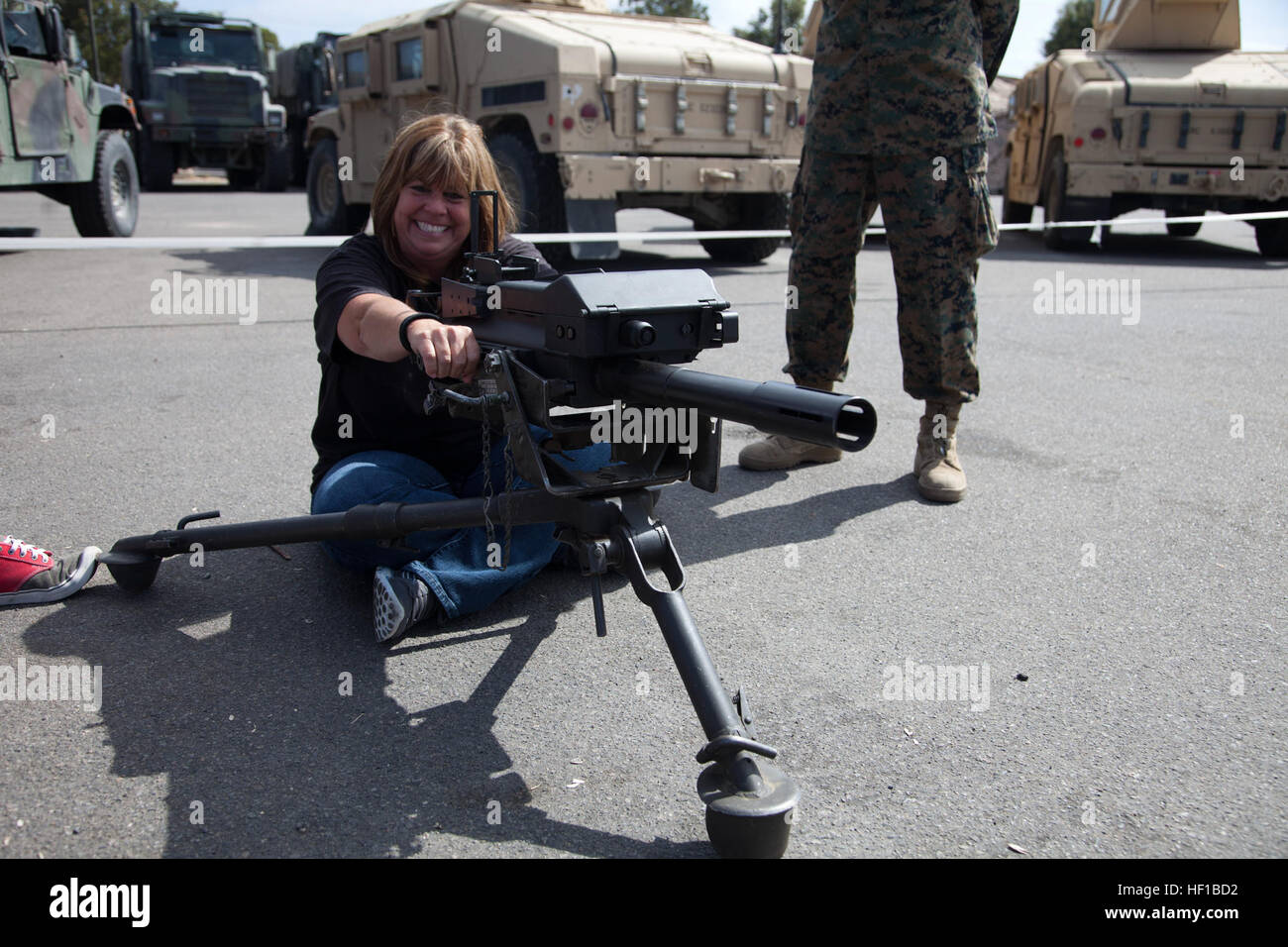 Janet Fliegel, wife of U.S. Marine Corps Sgt. Maj. Daniel Fliegel, Sgt. Maj. of Headquarters Battalion (HQBN), 1st Marine Division (1st MARDIV) poses with a MK 19 40 mm grenade machine gun during HQBN's Jane Wayne day aboard Camp Pendleton, Calif. June 22, 2013. Jane Wayne Day is an opportunity for family and friends of service members to participate in Marine Corps training, while strengthening family readiness through team building. (U.S. Marine Corps photo by Pfc. Adrianna Stalker, 1st Marine Division/Released) GI Joe and Jane Day Challenge 130622-M-HY842-093 Stock Photo