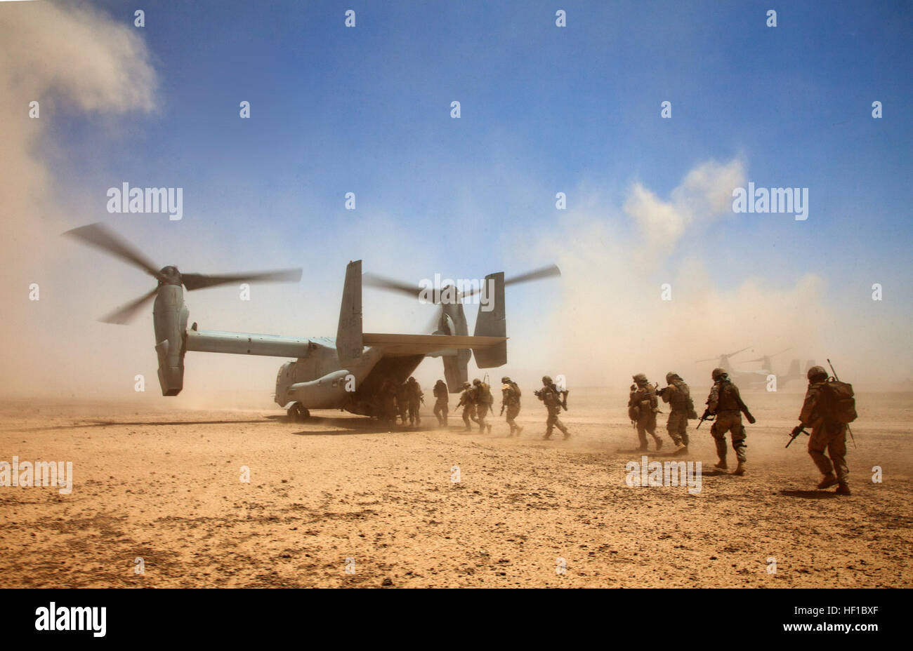 U.S. Marines assigned to Georgian Liaison Team 9 and Georgian soldiers assigned to the 33rd Light Infantry Battalion board a U.S. Marine Corps MV-22B Osprey tiltrotor aircraft assigned to Marine Medium Tiltrotor Squadron (VMM) 264 during Operation Northern Lion II July 3, 2013, in Helmand province, Afghanistan. Operation Northern Lion II was a Georgian-led operation conducted to deter insurgents, establish a presence and gather human intelligence. (U.S. Marine Corps photo by Cpl. Alejandro Pena/Released) 130703-M-YH552-899 (9241524618) Stock Photo