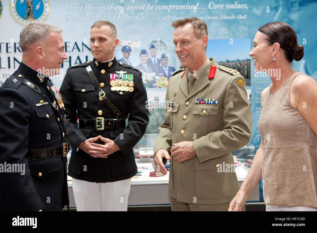 U.S. Marine Corps Maj. Gen. Kenneth F. McKenzie Jr., left, the Marine Corps representative to the Defense Department's Quadrennial Defense Review and the Sunset Parade host, speaks with a foreign military officer, second from right, and other guests during the parade reception at the Women in Military Service for America Memorial at Arlington National Cemetery in Arlington, Va., July 9, 2013. A Sunset Parade was held every Tuesday during the summer months. (U.S. Marine Corps photo by Cpl. Tia Dufour/Released) Sunset Parade 130709-M-KS211-013 Stock Photo