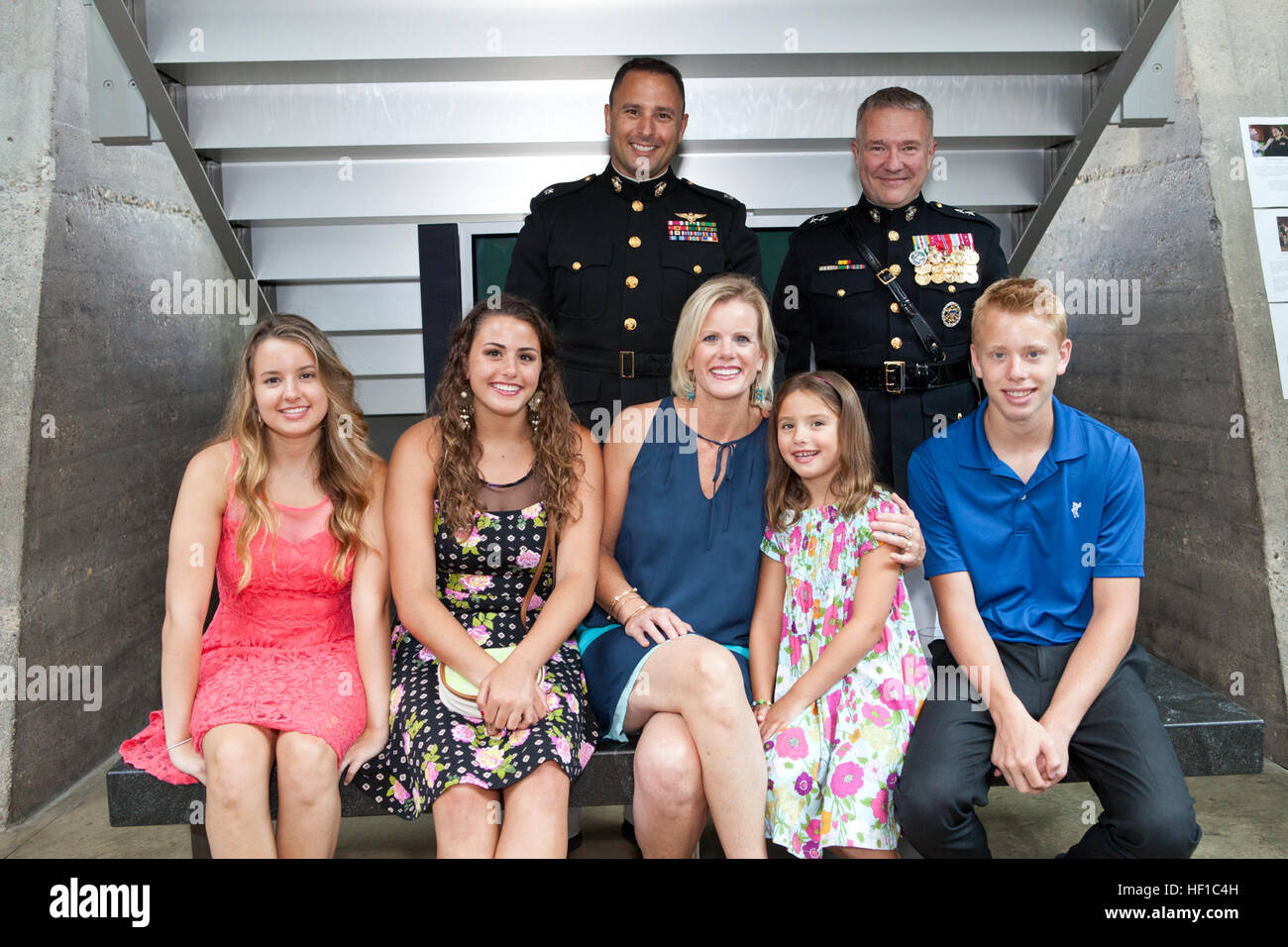 U.S. Marine Corps Maj. Gen. Kenneth F. McKenzie Jr., top right, the Marine Corps representative to the Defense Department's Quadrennial Defense Review and the Sunset Parade host, poses for a photo with a Marine Corps lieutenant colonel and his family during the parade reception at the Women in Military Service for America Memorial at Arlington National Cemetery in Arlington, Va., July 9, 2013. A Sunset Parade was held every Tuesday during the summer months. (U.S. Marine Corps photo by Cpl. Tia Dufour/Released) Sunset Parade 130709-M-KS211-029 Stock Photo