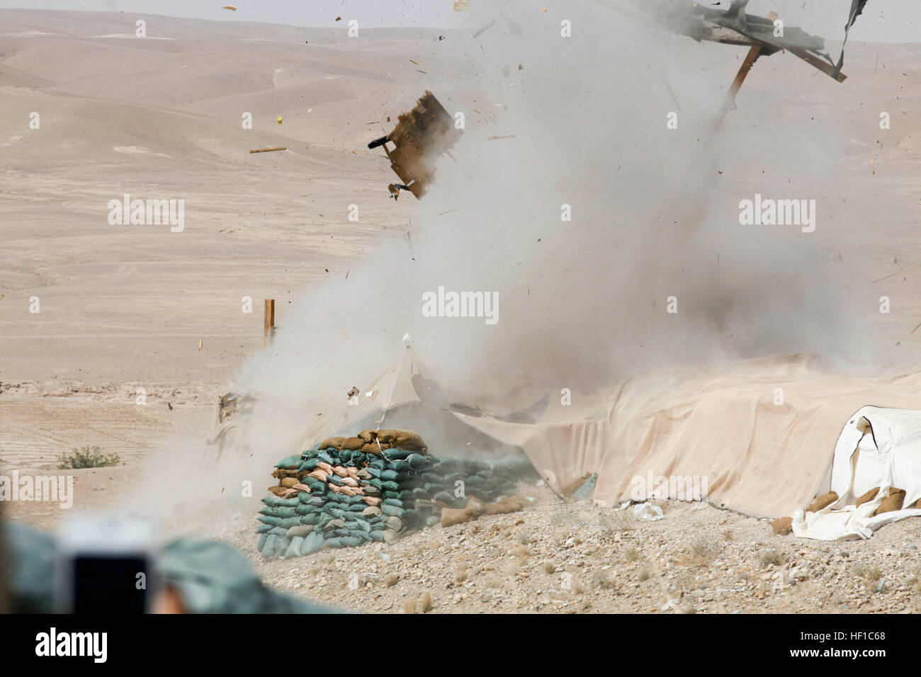 An explosive charge detonates during the demolition of Combat Outpost Ertoba in Musa Qala district, Helmand province, Afghanistan, July 11, 2013. The 3rd Combat Engineer Battalion (CEB) demolished COP Ertoba in preparation for the retrograde of coalition forces from Afghanistan. (U.S. Marine Corps photo by Cpl. Trent A. Randolph/Released) 3rd CEB Demolishes COP Ertoba 130711-M-TQ917-114 Stock Photo