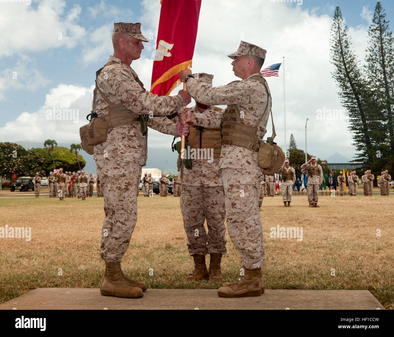 U.S. Marine Corps Colonel Timothy E. Winand (Left), Commanding Officer of Third Marine Regiment, receives the unit colors from Colonel Nathan I. Nastase (Right), during 3rd Marine Regiment's change of command ceremony at Dewey Square, Marine Corps Base Hawaii, Kaneohe Bay on July 17th, 2013. The ceremony marked the passing of command between Colonel Nastase, former Commanding Officer of 3rd Marine Regiment and Colonel Winand. (U.S. Marine Corps photo by Private 1st Class Roberto Villa Jr./Released) Third Marine Regiment Change of Command 130717-M-BN443-013 Stock Photo