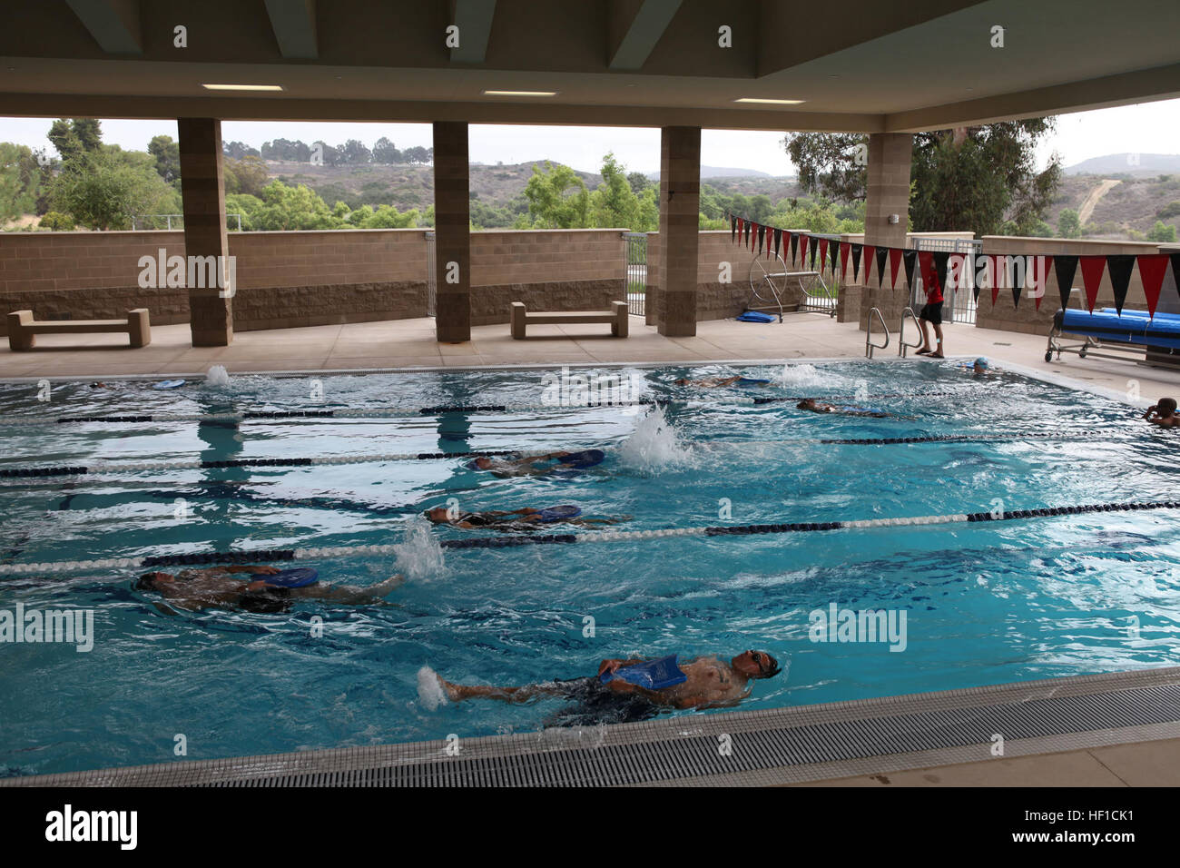 Swimmers focus on proper form while practicing backstroke technique