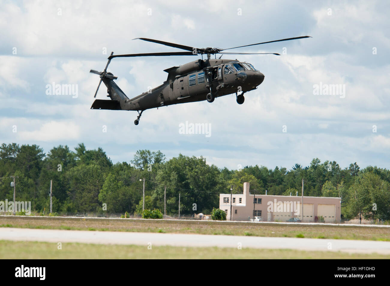 UH-60M Black Hawks from the 3-238th General Support Aviation Battalion from Grand Ledge, Mich., land at Grayling Airfield, Grayling, Mich., Aug. 3, 2013. The 3-238th is participating in Exercise Northern Strike 2013, a joint multinational combined arms training exercise conducted in Michigan. (U.S. Air National Guard photo by Master Sgt. Scott Thompson/released) A U.S. Army UH-60M Black Hawk helicopter assigned to the 3rd Battalion, 238th Aviation Regiment prepares to land at Grayling Airfield in Grayling, Mich., Aug. 3, 2013, during Northern Strike 130803-Z-GS745-013 Stock Photo