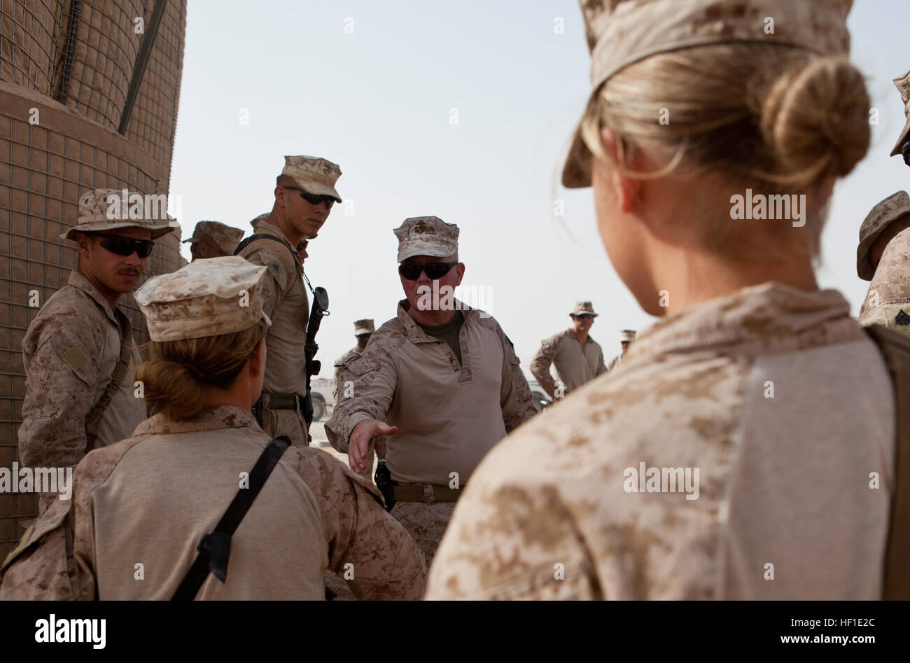 Maj. Gen. Walter Miller (center), commanding general Regional Command (Southwest), greets Marines with Combat Logistics Regiment 2, RC(SW), at the site of recent infrastructure improvement projects at Camp Dwyer, Afghanistan, Aug. 11, 2013. Miller visited the troops to maintain an on-the-ground feel for conditions and inspect recent construction projects. Maj. Gen. Miller visits Camp Dwyer troops 130811-M-ZB219-300 Stock Photo
