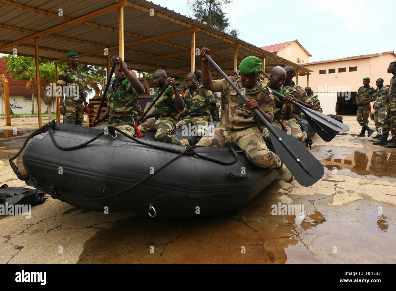 Senegalese Companie de Fusilier Marine Commandos practice basic boat commands in a Zodiac after receiving classes by Marines and sailors with Special-Purpose Marine Air-Ground Task Force Africa 13 on Bel Air Naval Base in Dakar, Senegal, Aug. 12, 2013. Special-Purpose MAGTF Africa strengthens U.S. Marine Corps Forces Africa and U.S. Africa Command's ability to assist partner nations in theater security cooperation and military-to-military engagements. Special-Purpose MAGTF Africa's current iteration is the fourth rotation working with the Senegalese Forces. (U.S. Marine Corps photo by Cpl. Rya Stock Photo