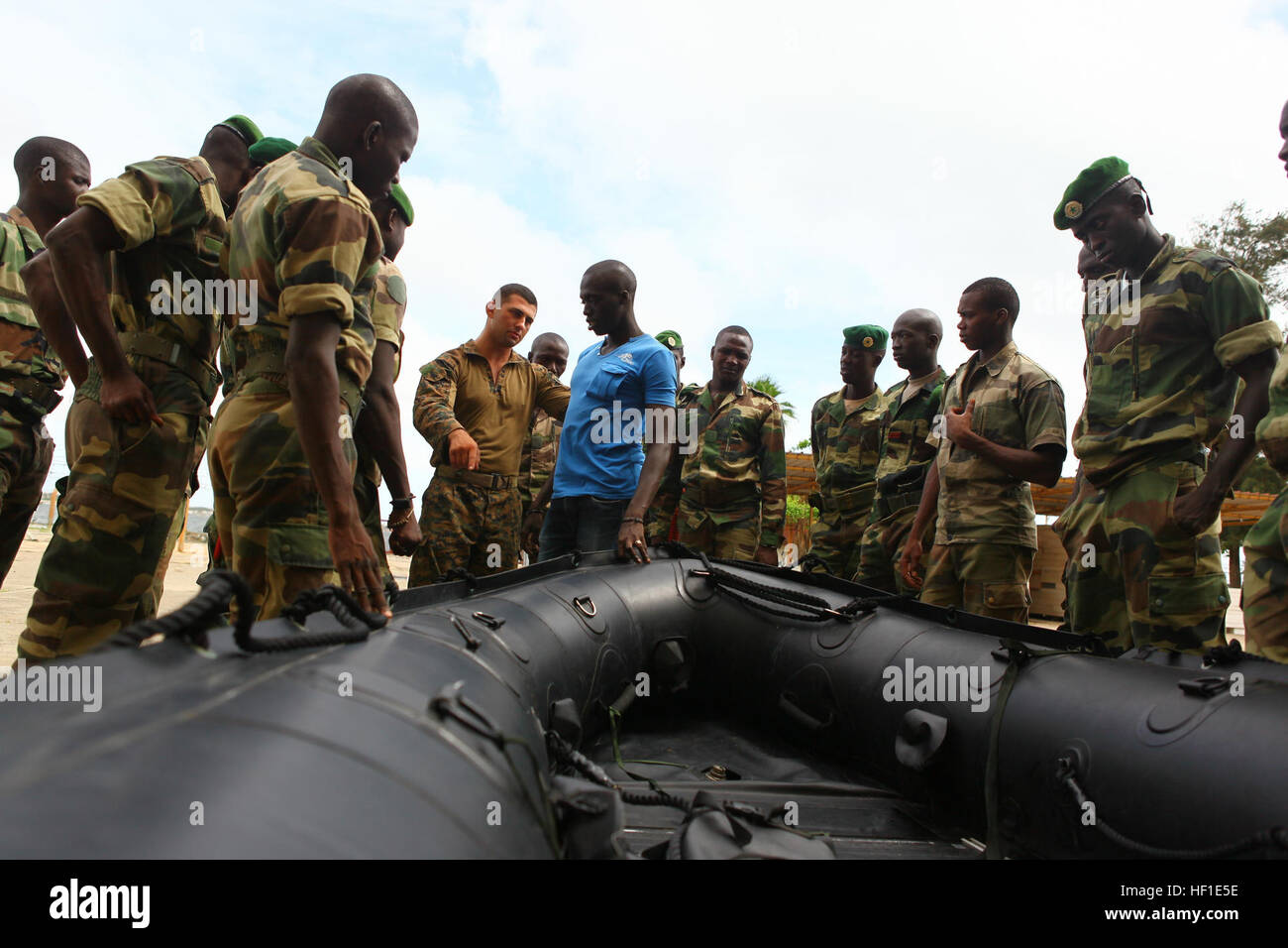 Lance Cpl. Wade Patten, a reconnaissance Marine with Special-Purpose Marine  Air-Ground Task Force Africa 13, explains the different components of the  Zodiac boat to Senegalese Companie de Fusilier Marine Commandos on Bel