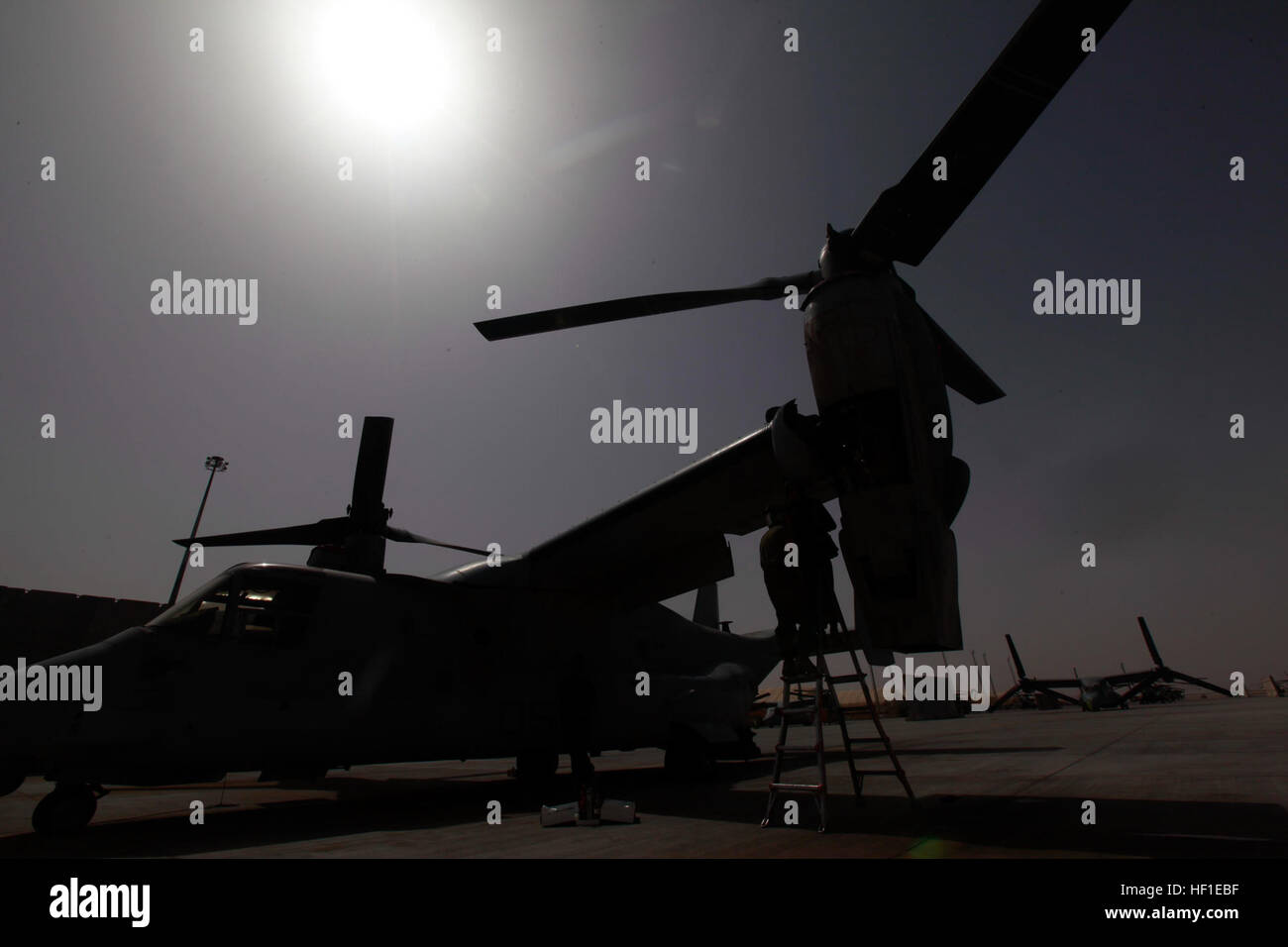 U.S. Marines with Marine Medium Tiltrotor Squadron 165, conduct maintenance on a MV-22 Osprey aircraft at Camp Bastion, Helmand province, Afghanistan, Aug. 16, 2013. The maintenance ensured the aircraft was safe for flight. (U.S. Marine Corps photo by Cpl. Ashley E. Santy/Released) VMM-165 Conducts Maintenance 130816-M-BU728-125 Stock Photo