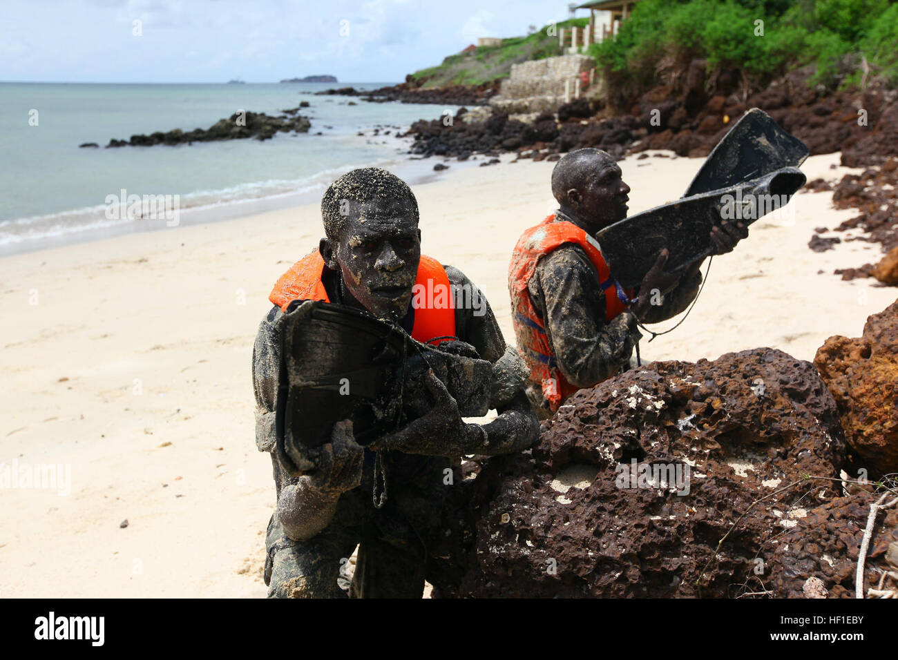 Senegalese Companie de Fusilier Marine Commandos post security after swimming ashore ahead of their team ensuring the beach is clear of enemies or obstacles prior to the team insertion on Bel Air Naval Base in Dakar, Senegal, after being taught by Marines and sailors with Special-Purpose Marine Air-Ground Task Force Africa 13, Aug. 16, 2013. Special-Purpose MAGTF Africa strengthens U.S. Marine Corps Forces Africa and U.S. Africa Command's ability to assist partner nations in theater security cooperation and military-to-military engagements. Special-Purpose MAGTF Africa's current iteration is t Stock Photo