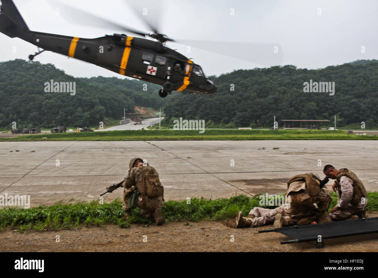 A UH-60 Black Hawk helicopter takes off after picking up a simulated casualty during medical evacuation training between U.S. Marines, soldiers and Navy corpsmen at the Rodriguez Live-Fire Complex Aug. 18 as part of the Korean Marine Exchange Program 13-8. KMEP 13-8, a combined, annual training exercise that enhances the combat readiness and interoperability of Republic of Korea and U.S. Marine Corps forces, is just one in a series of continuous, combined training exercises designed to promote stability on the Korean Peninsula, enhance the alliance, and strengthen ROK and U.S. military capabil Stock Photo