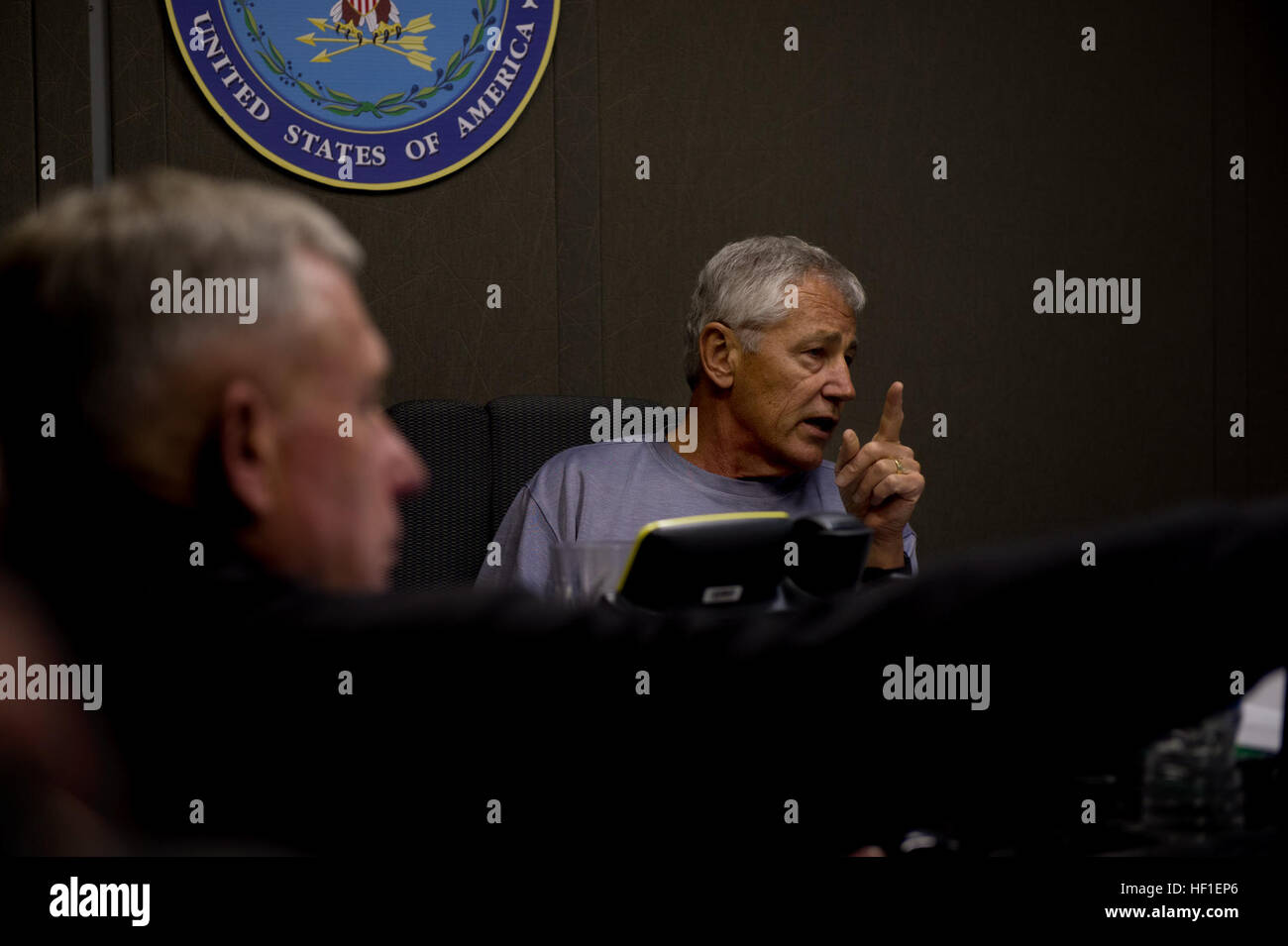 Secretary of Defense Chuck Hagel, right, briefs members of the press aboard a plane en route to Malaysia Aug. 23, 2013. Hagel was on a nine-day trip to meet with defense leaders in Malaysia, Indonesia, Brunei and the Philippines. (DoD photo by Sgt. Aaron Hostutler, U.S. Marine Corps/Released) Secretary of Defense 130823-M-EV637-062 Stock Photo