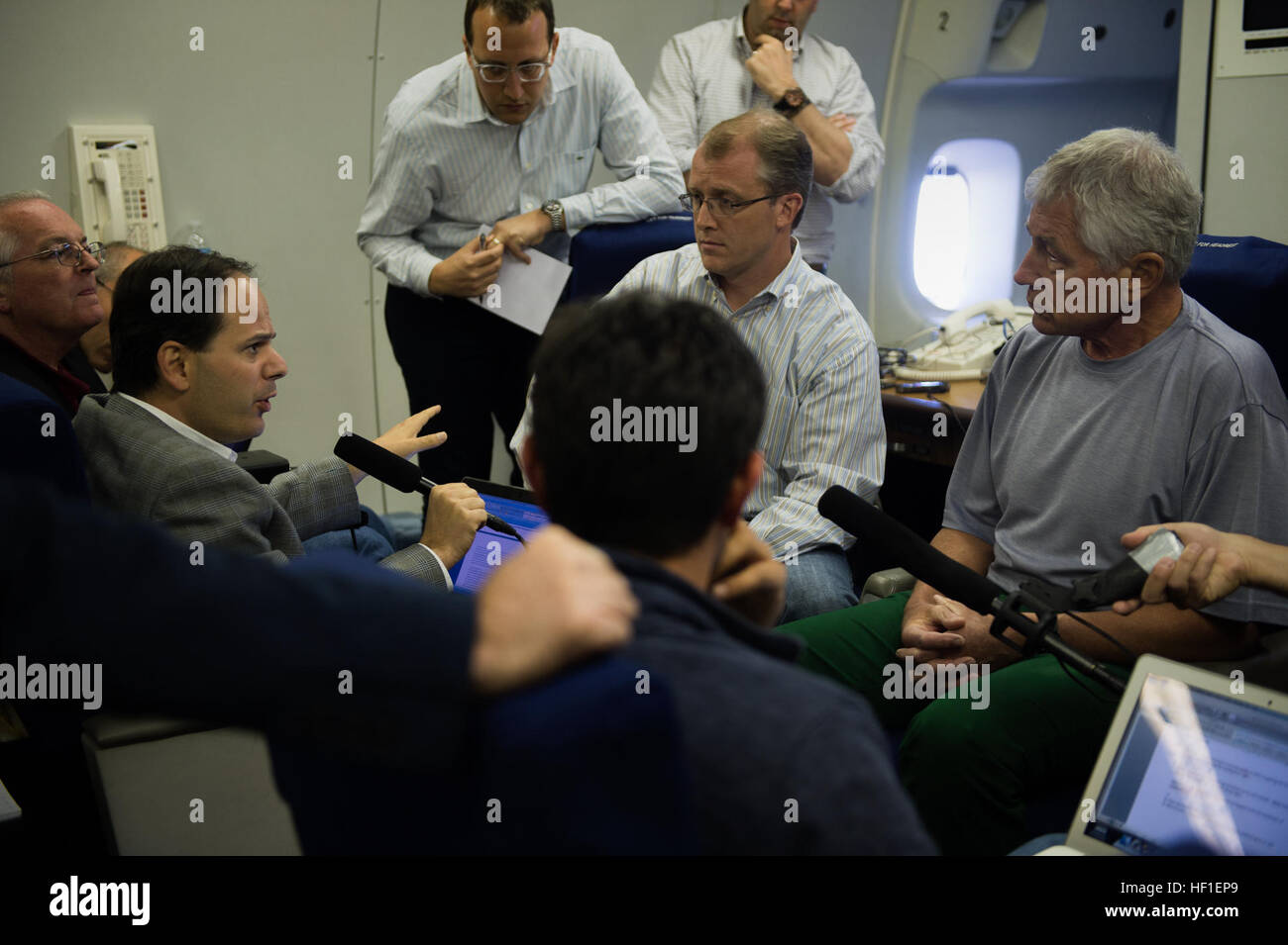 U.S. Secretary of Defense Chuck Hagel, right, listens during a press briefing aboard a plane en route to Malaysia Aug. 23, 2013. Hagel was on a nine-day trip to meet with defense leaders in Malaysia, Indonesia, Brunei and the Philippines. (DoD photo by Sgt. Aaron Hostutler, U.S. Marine Corps/Released) Secretary of Defense 130823-M-EV637-105 Stock Photo