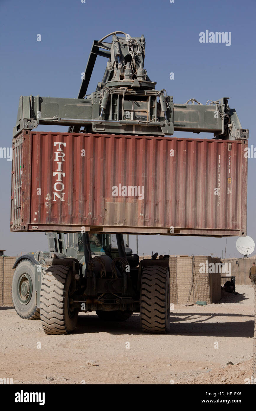 A heavy equipment operator moves a storage unit at Forward Operating