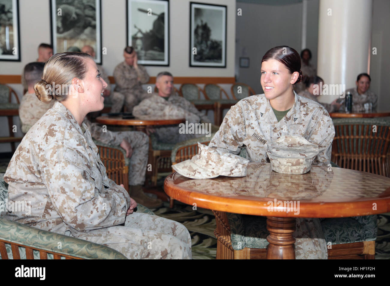 Lance Corporals Kamber L. Borders, left, and Ashlee N. Brown discuss equality during a Women's Equality Day observance luncheon Aug. 30 at Camp Hansen. Borders is a field radio operator and systems administrator with G-6, Communication and Information Systems, III Marine Expeditionary Force. Brown is a data systems technician with 7th Communication Battalion, III MHG, III MEF. (U.S. Marine Corps photo by Lance Cpl. Diamond N. Peden/Released) Many observe, commemorate 19th Ammendment 130830-M-OY715-015 Stock Photo